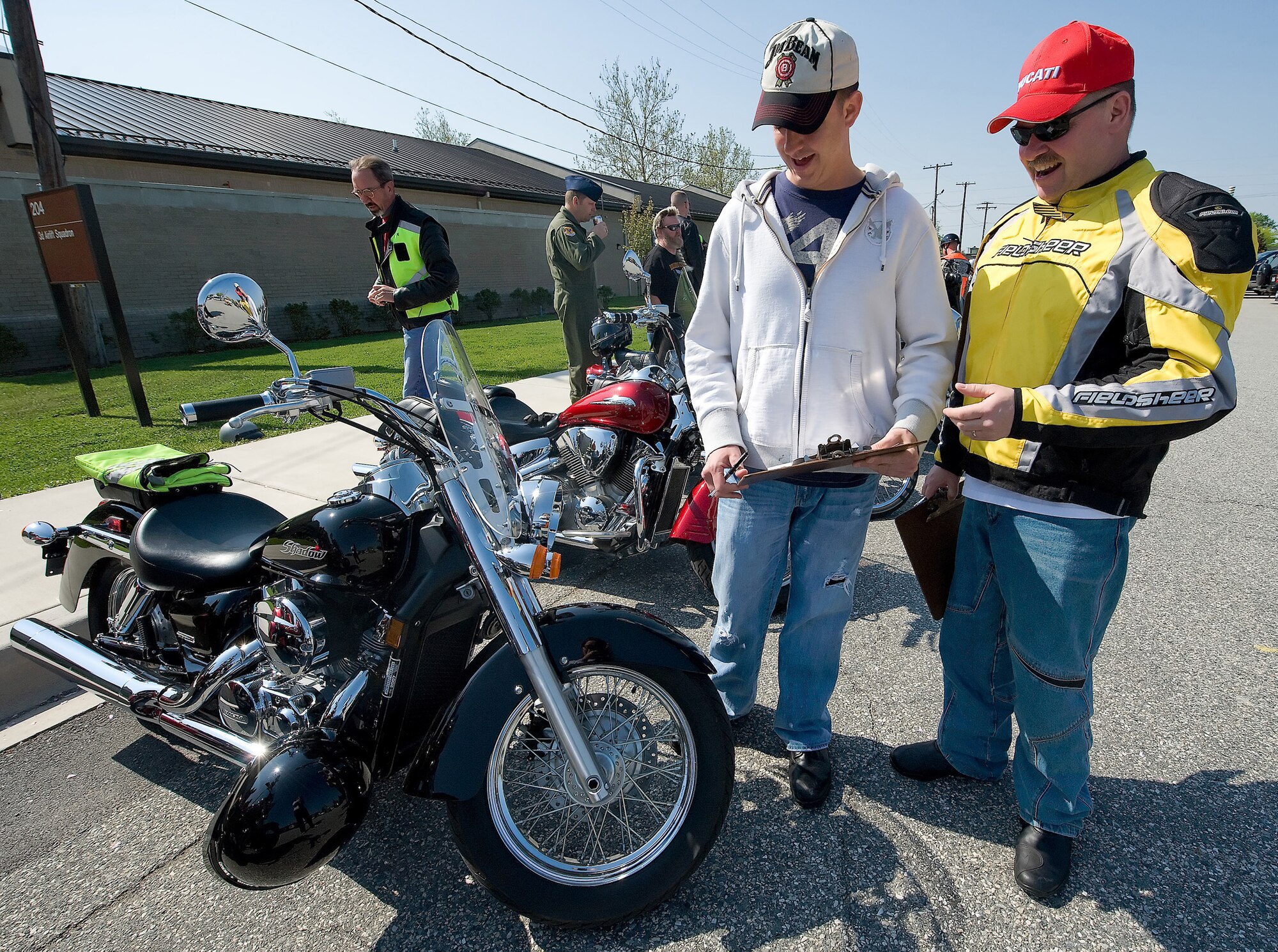 Senior Airman Brian Freeman, 436th Medical Group, and Senior Master Sgt. Edward Renneckar, 436th Airlift Wing, conduct a pre-ride inspection during the Motorcycle Safety and Awareness Day April 23 hosted by the 436th Operations Group. Approximately 50 Team Dover members participated in the event. (U.S. Air Force photo/ Brianne Zimny)