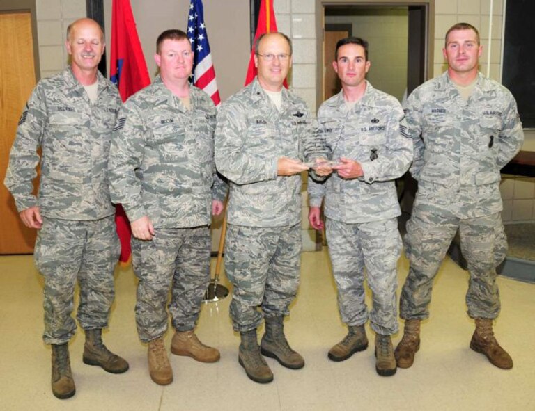 Team Red from the 188th Fighter Wing, from left: Master Sgt. Mark McDaniel, Tech Sgt. Chad Niccum, Master Sgt. Ron White, Jr. and Senior Airman Westly Wagner. Presenting the trophy is Brig. Gen. Travis D. Balch, Chief of Staff, Arkansas Air National Guard. Team Red won the overall team championship at the 2010 Arkansas National Guard Adjutant General's (TAG) Marksmanship Sustainment Training Exercise held April 24-25 at Camp Joseph T. Robinson. (U.S. Army photo by Sgt. 1st Class Chris Durney/Arkansas National Guard Public Affairs)