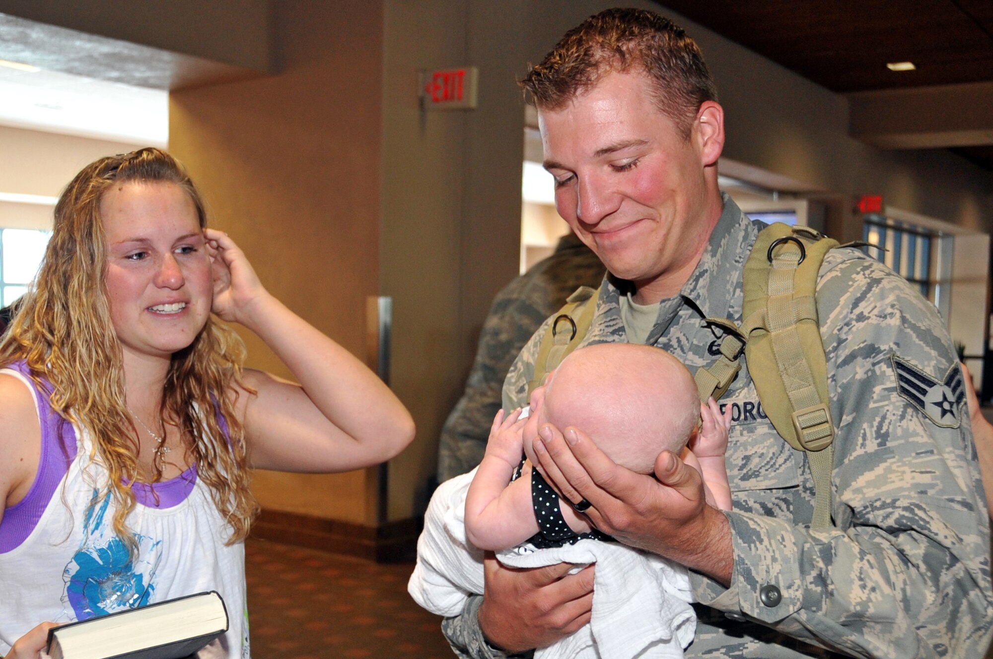 SrA Miles Corbin, EOD, was all smiles when he was greeted by his wife, Holly and his 11 month old daughter, Adelynn.  SrA Corbin returned from deployment along with two other EOD airmen April 15.

U.S. Air Force Photo by Elizabeth Martinez