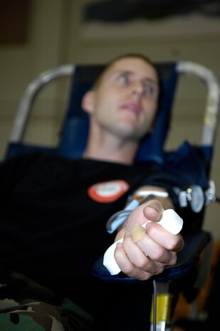 Staff Sgt. Joshua Cox sits patiently as he donates blood during the Red Cross Blood Drive held at the Fitness and Sports Center on Joint Base Charleston, S.C., April 21, 2010. O-Negative blood type is the most needed blood because everyone can receive it. The blood donated at Joint Base Charleston is distributed to hospitals around South Carolina. Sergeant Cox is a military training leader with the 373rd Training Squadron. (U.S. Air Force Photo/Airman 1st Class Lauren Main) 