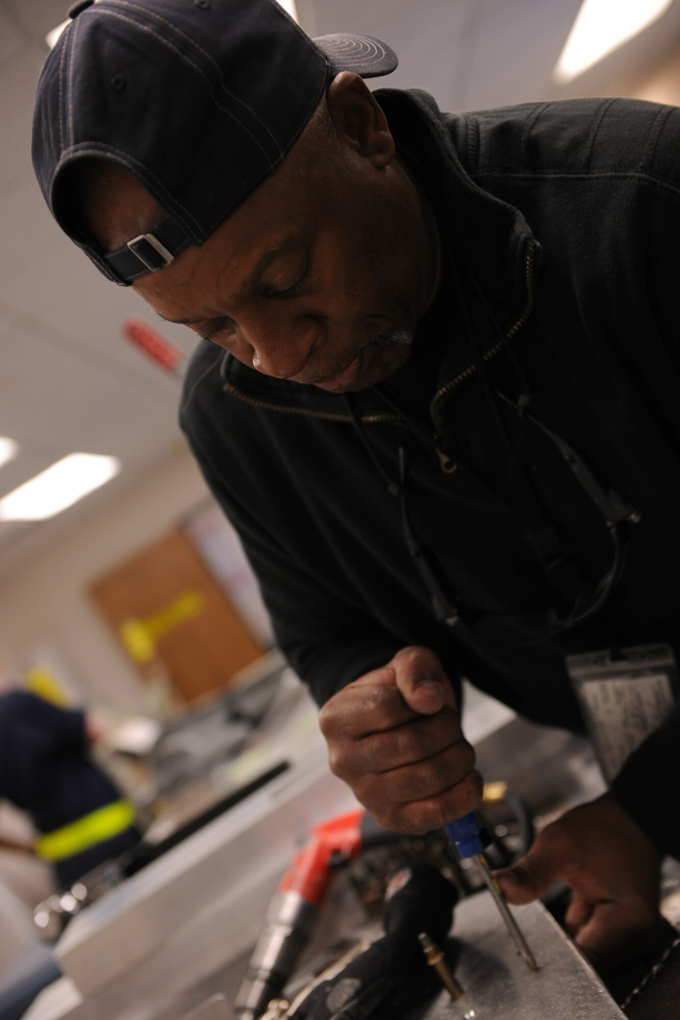 MOODY AIR FORCE BASE, Ga. -- Dennis Williams, 23rd Equipment Maintenance Squadron aircraft maintenance member, fastens together a panel for a new radio system for an HC-130P Combat King here April 1. Mr. Williams used blueprints and technical orders to produce 10 new panels from scratch for the C-130 aircraft. (U.S. Air Force photo by Airman 1st Class Benjamin Wiseman/RELEASED)