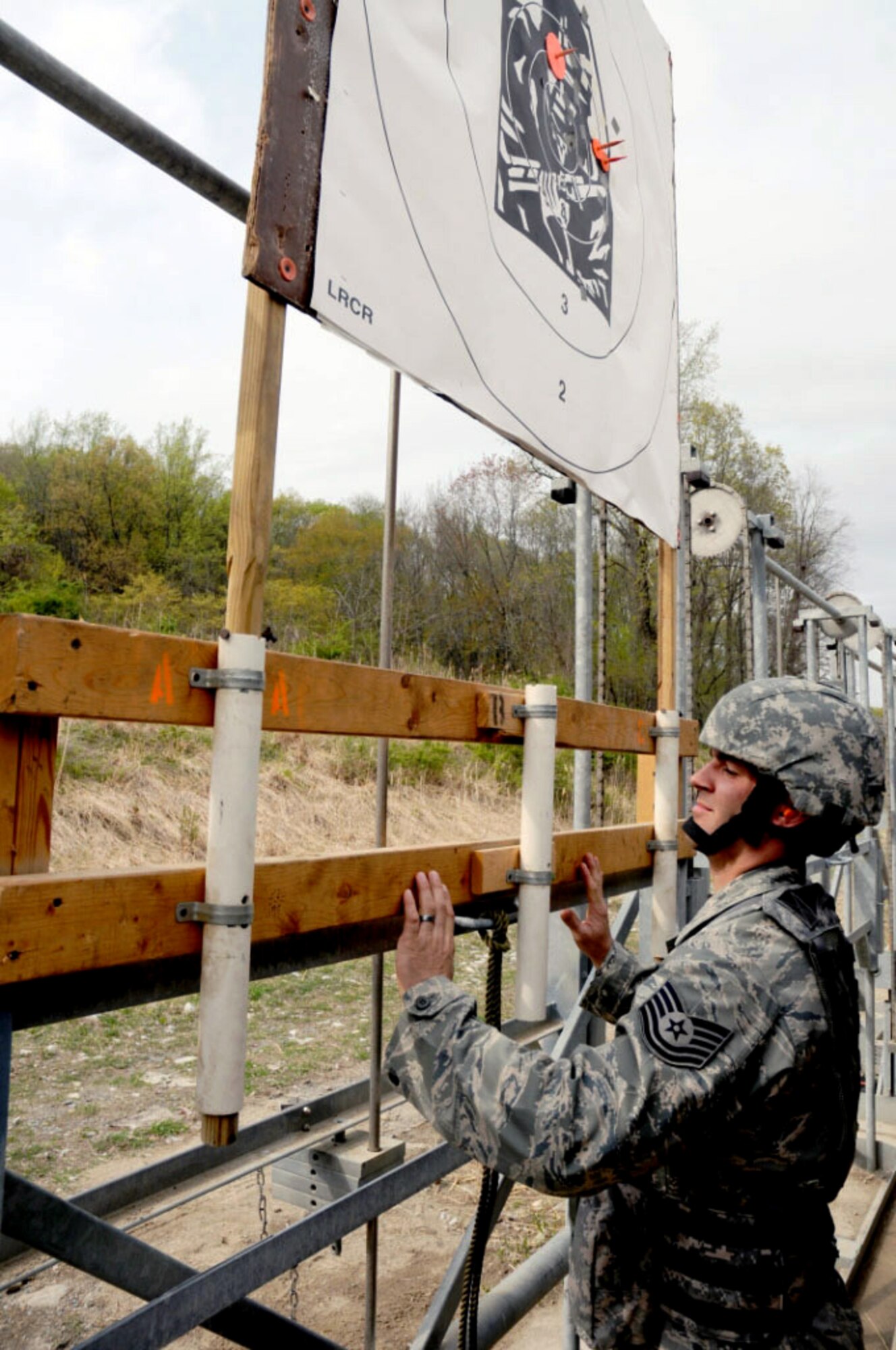 Tech. Sgt. Daniel Owczarczak marks and raises a target for a shooter April 17, 2010, during the zeroing phase of the 31st annual The Adjutant General Match held at Camp Smith, N.Y.  Air Guard security forces personnel are deployed around the world and engaging in all Air Force security forces missions, except the military working dog program. Sergeant Owczarczak is a security forces Airman with the New York Air National Guard's 107th Security Forces Squadron at Niagara Falls Air Reserve Station, N.Y.   (U.S. Army photo/Spc. Leigh Campbell)

