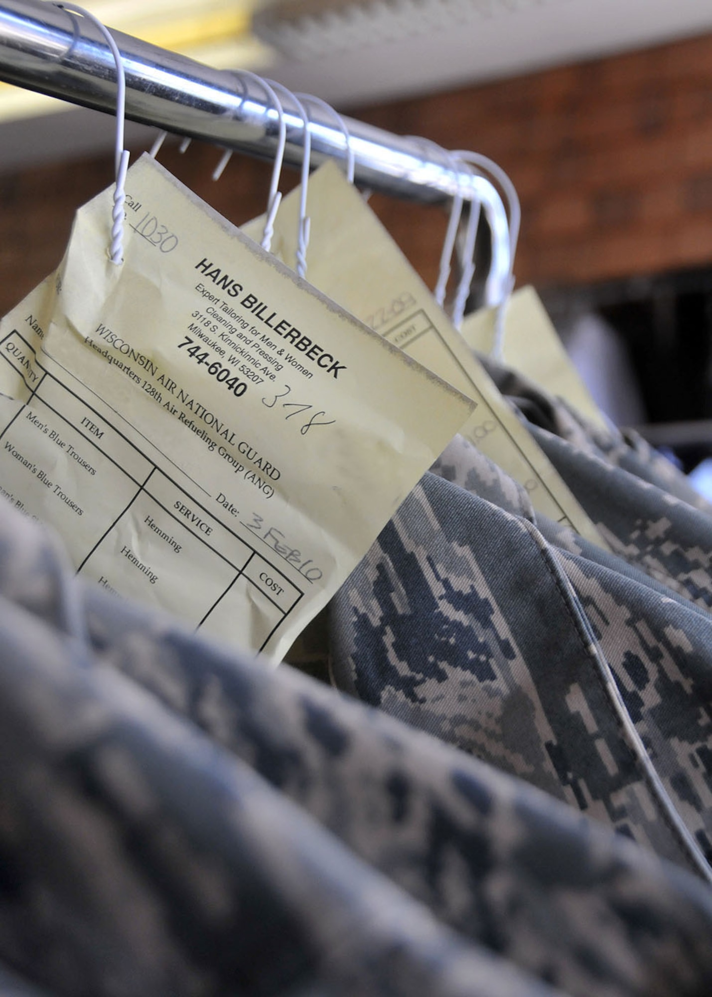 A rack of completed uniforms await pick up at Han’s Tailor shop.