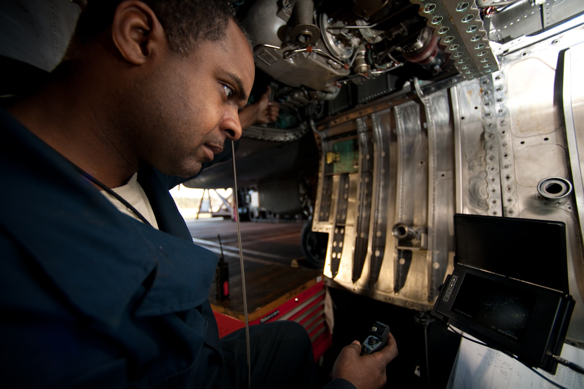 Tech. Sgt. Willie Mitchell, a jet engine mechanic with the 493rd Aircraft Maintenance Unit, watches a camera monitor while he “bore scopes” an F-15 engine April 23 at RAF Lakenheath, England. The bore scope is a small camera system that enables Sergeant Mitchell to inspect the rotors while his coworker slowly turns the engine shaft. (U.S. Air Force photo by Tech. Sgt. Nathan Gallahan)