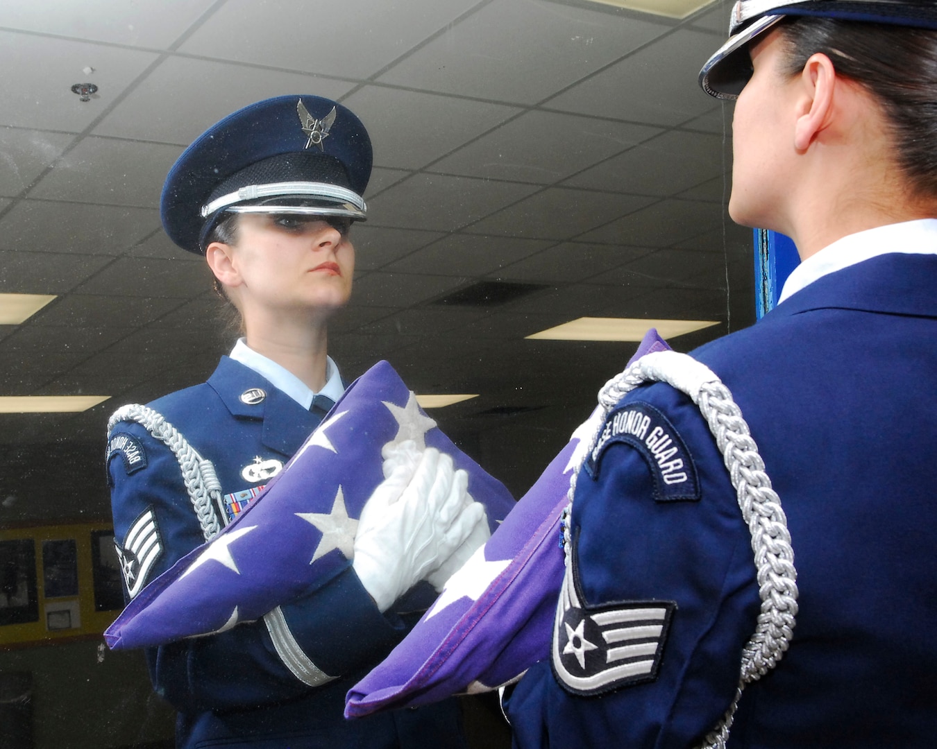 Staff Sgt. Ashley Atkinson, 59th Laboratory Squadron, looks over her form before presenting the flag to the next of kin during a Lackland Honor Guard practice session. Last year, the Lackland Honor Guard rendered honors at 1, 031 funerals of deceased Air Force and Army Air Corps veterans (U.S. Air Force photo by Alan Boedeker).
