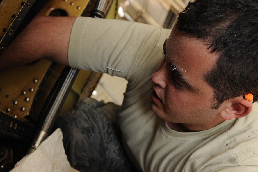 MOODY AIR FORCE BASE, Ga. -- Airman 1st Class Joshua Beauchamp, 23rd Equipment Maintenance Squadron aircraft maintenance member, drills out pop rivets to remove a nacelle door hinge from an A-10C Thunderbolt II aircraft here April 1. The hinge was cracked in three places and had to be fixed before the aircraft could be placed on flying status. (U.S. Air Force photo by Airman 1st Class Benjamin Wiseman/RELEASED)