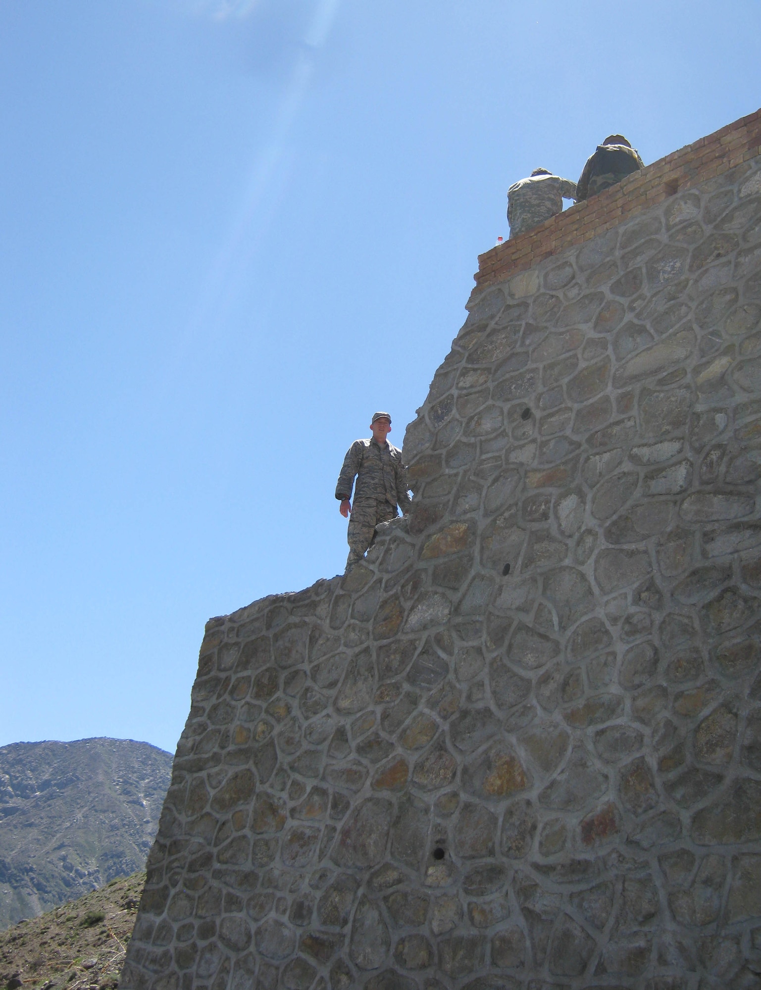 Second Lt. Jason Adams (left), Provincial Reconstruction Team Panjshir civil engineer, inspects a retaining wall at Pyawusht, Panjshir Province, Afghanistan, April 19. Adams and some other PRT engineers visited five work sites and held two meetings in what Adams called a ?successful day.? (U.S. Air Force Photo by 2nd Lt. Jason Smith, PRT Panjshir Public Affairs)
