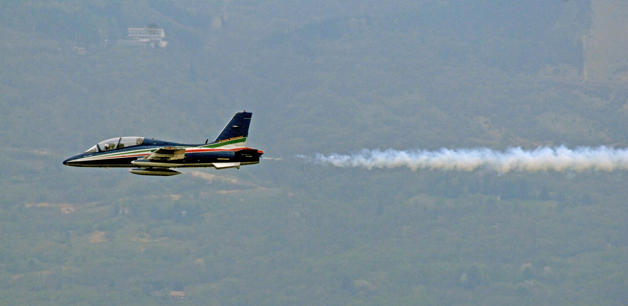 A pilot from the Italian aerobatic team, Frecce Tricolori, performs a practice run April 23 over Aviano Air Base. Traditionally, the aerobatic team concludes their training here at Aviano the Friday prior to the beginning of their performance season. For more information on the Frecce Tricolori, visit www.freccetricolori.org. (U.S. Air Force photo/Staff Sgt. Julius Delos Reyes)
