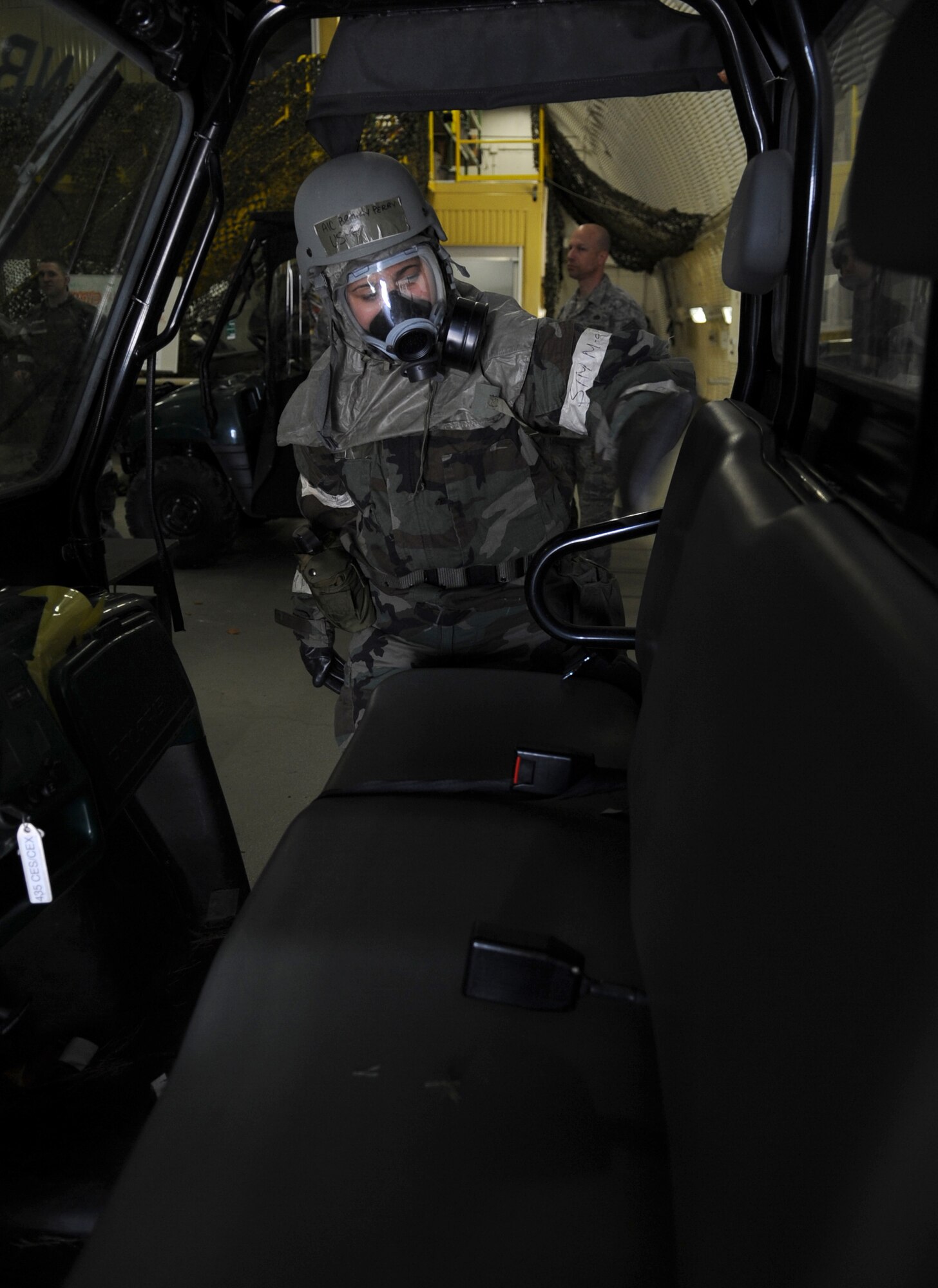 U.S. Air Force Airman 1st Class Brittany Perry, 86th Airlift Wing Public Affairs photographer, demonstrates the proper way to check for contamination of chemical gear during chemical, biological, radiological, nuclear, and high yield explosives training, Ramstein Air Base, Germany, April 23, 2010.  Preparation for the ORI allows Air Force members to build on strengths and indentify weaknesses in order to better support future missions. (U.S. Air Force Photo by Airman 1st Class Caleb Pierce)