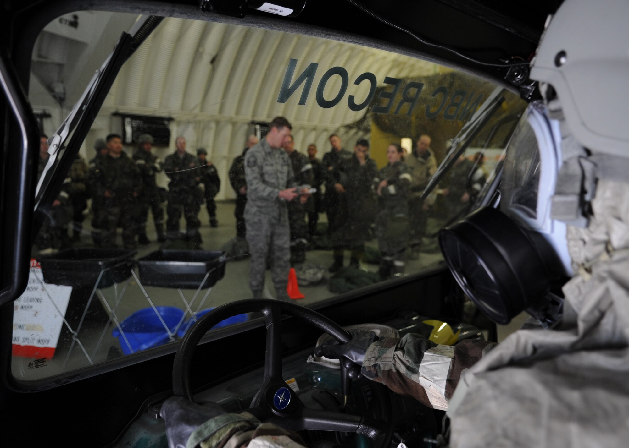 U.S. Air Force Airman 1st Class Brittany Perry, 86th Airlift Wing Public Affairs photographer, simulates being in a contaminated vehicle during chemical, biological, radiological, nuclear, and high yield explosives training, Ramstein Air Base, Germany, April 23, 2010.  Preparation for the ORI allows Air Force members to build on strengths and indentify weaknesses in order to better support future missions. (U.S. Air Force Photo by Airman 1st Class Caleb Pierce)