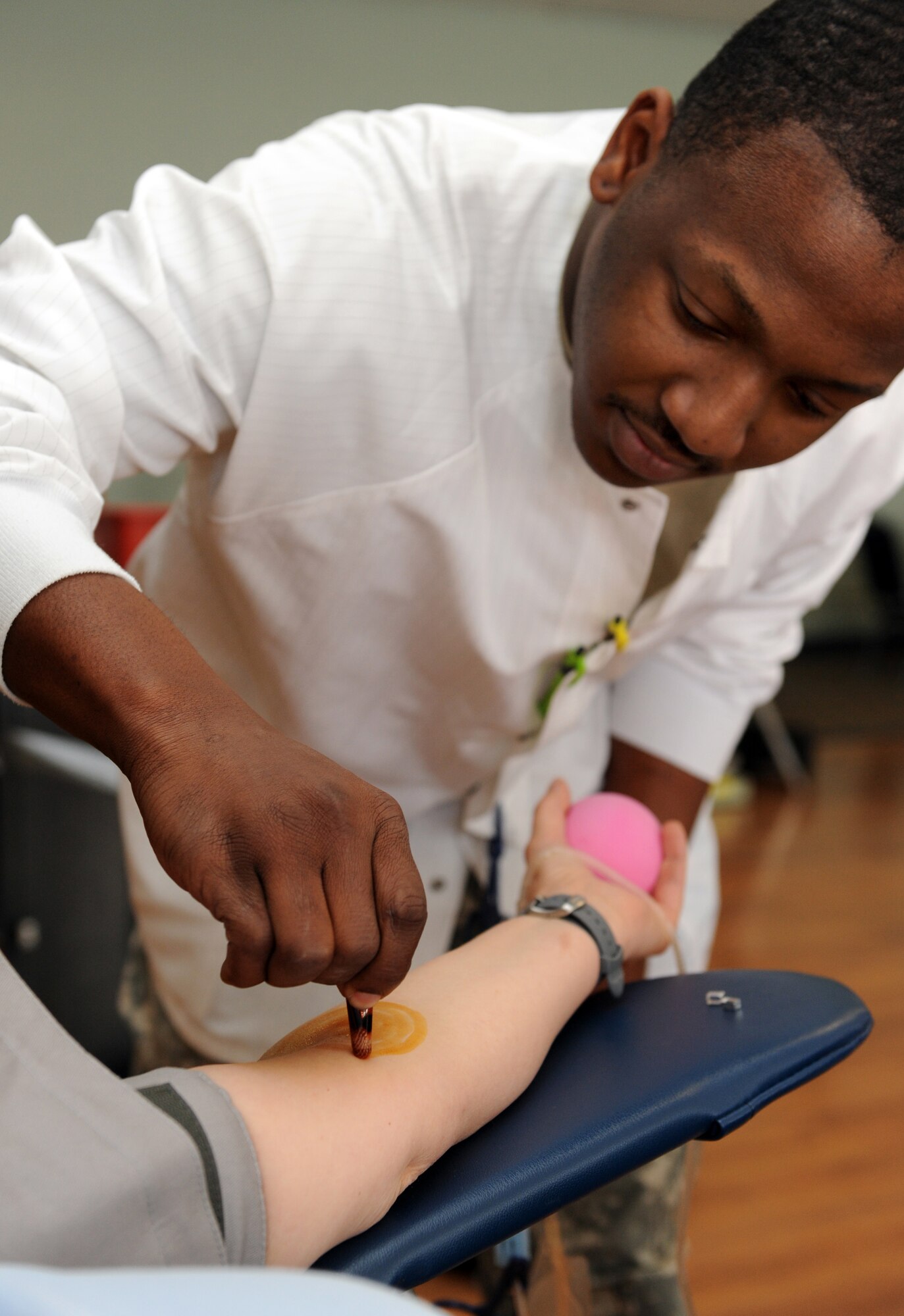 MOUNTAIN HOME AIR FORCE BASE, Idaho -- Spec. Jason Routt, B Company Madigan Army Medical Center lab technician from Ft. Lewis Washington, sterilizes Tina Birch's arm before drawing blood at the Armed Services Blood Program blood drive at the community center April 19. The goal for the two-day blood drive was to collect 200 units of blood. According to www.militaryblood.dod.mil, the ASBP plays a key role in providing quality blood products for service members and their families in both peace and war. (U.S. Air Force photo by Airman 1st Class Debbie Lockhart)
