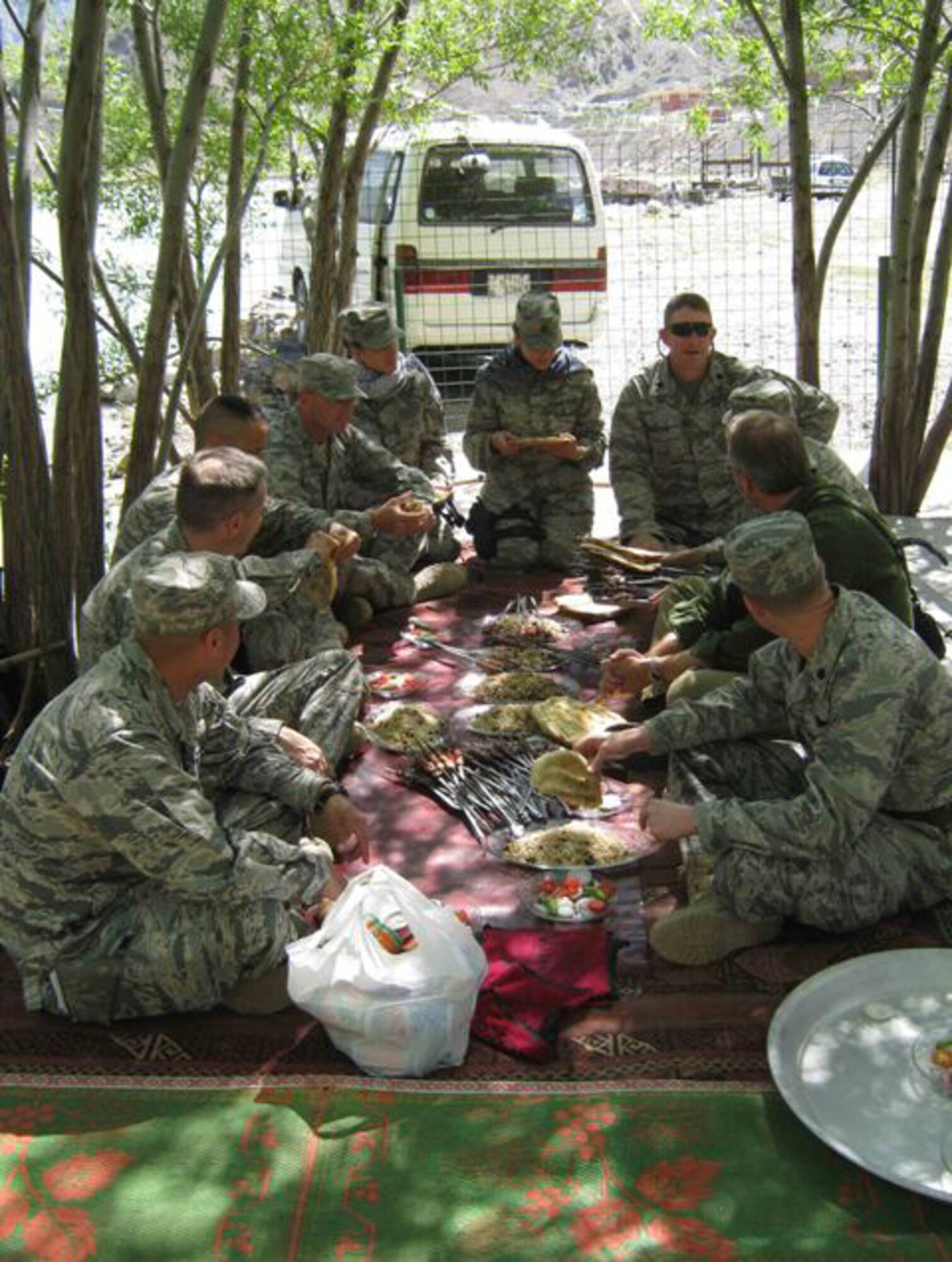 U.S. Air Force Lt. Col. Curtis Velasquez (front, left), Provincial Reconstruction Team Panjshir commander and Abilene, Kan., native, and James DeHart, U.S. Department of State and PRT Panjshir director (second on right), host a traditional Afghan lunch with visitors from Bagram Air Field, April 25. A local restaurant served the meal that included kabobs, rice, vegetables and nan, or Afghan bread. To wash the meal down, the group was served Panjshir water which is locally produced and bottled. (Photo by U.S. Air Force 2nd Lt. Jason Smith, Panjshir Provincial Reconstruction Team Public Affairs)

                               