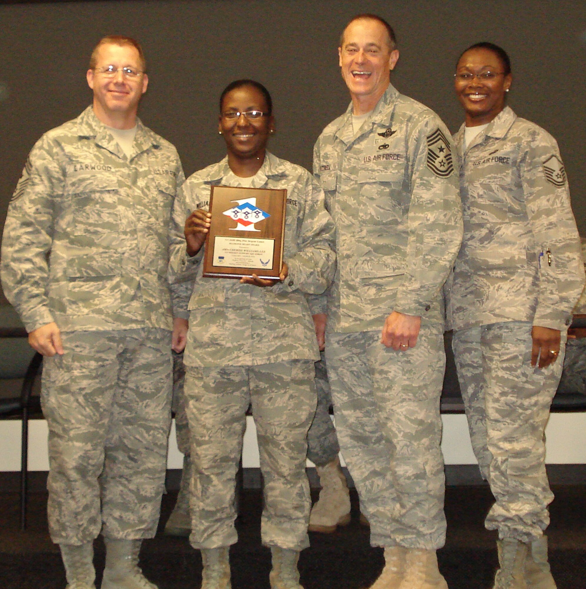Airman 1st Class Cherise Williams-Lee, 315th Airlift Wing Charleston Air Force Base S.C. is presented her Diamon Sharp Award by 22nd Air Force Command Chief Master Sergeant Steven Larwood, 315th Airlift Wing Command Chief Master Sergeant Ben Futrell and 315th AW Mission Support Squadron First Sergeant MSgt Kimberly Kelly.
The Diamond Sharp Award is presented to members who epitomize the Air Force Core Values. (U.S. Air Force photo)

