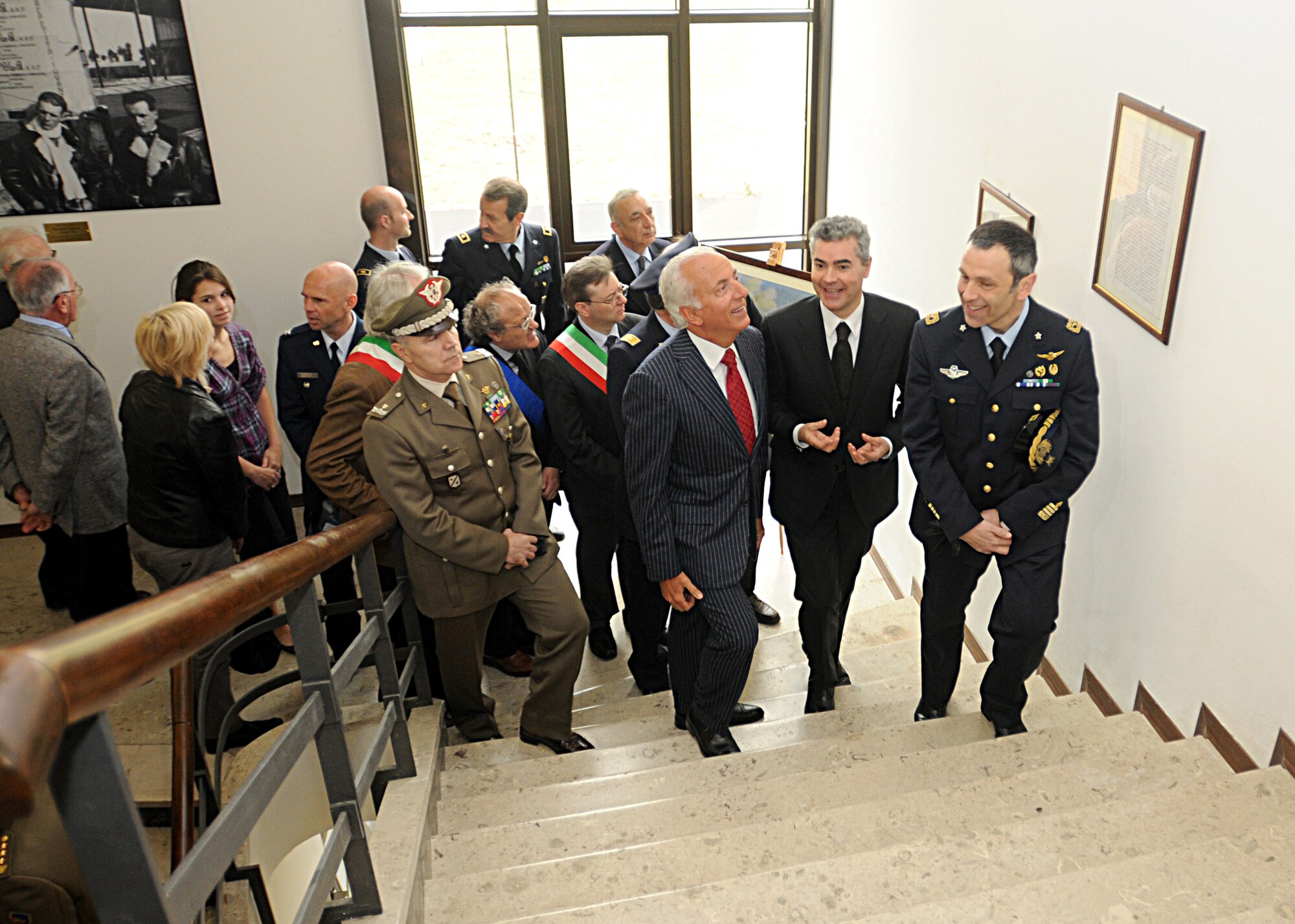 Distinguished guests of Col. Filippo Zampella, Italian base commander, take a tour April 23 of the newly renovated Italian Air Force headquarters building in Area F.  During the tour, participants saw a variety of historical photos and uniforms from Aviano and Italian air force history.  (U.S. Air Force photo by Senior Airman Tabitha M. Mans)