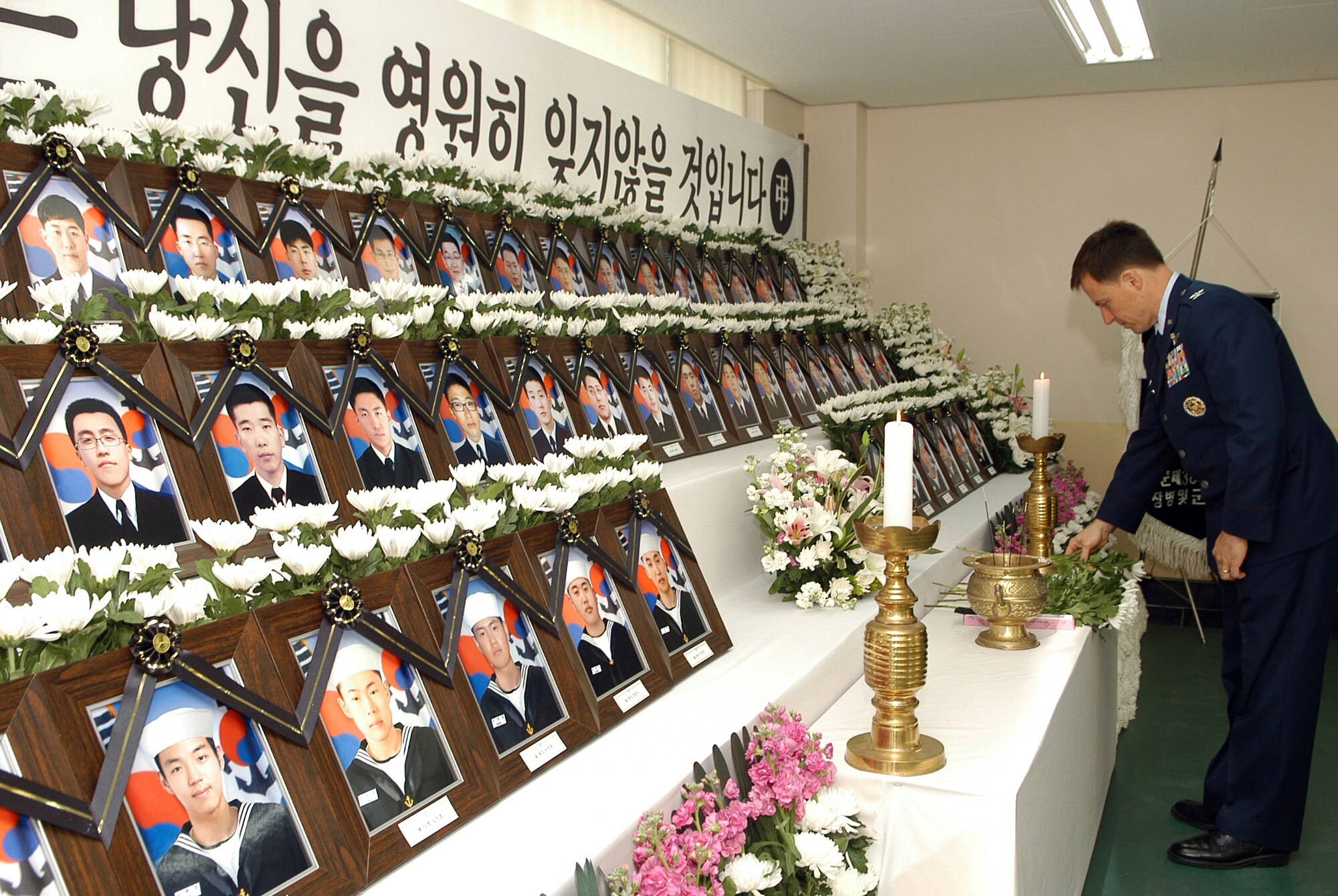 Col. Robert P. Givens, 8th Fighter Wing commander pays his respects and lay flowers  to mourn the Republic of Korea Navy sailors killed in the sinking of the Cheonan naval patrol ship last month. 
The Republic of Korea government has declared April 25-29 a 5-day mourning period for the sailors. 

Places have been set up at military bases around the country where people can go and express their condolences. 

The designated location here at Kunsan AB is at the ROKAF visitor center located at the back gate. A white banner of mourning is displayed on the front of the building.

Anyone wishing to express their condolences at the loss of our Korean Navy allies can do so at the visitor center between the hours 9 a.m. - 9 p.m., April 25 - 29. 

Flowers will be available to lay as a memorial to the fallen sailors.
Dress will be uniform of the day. (Courtesy photo)



