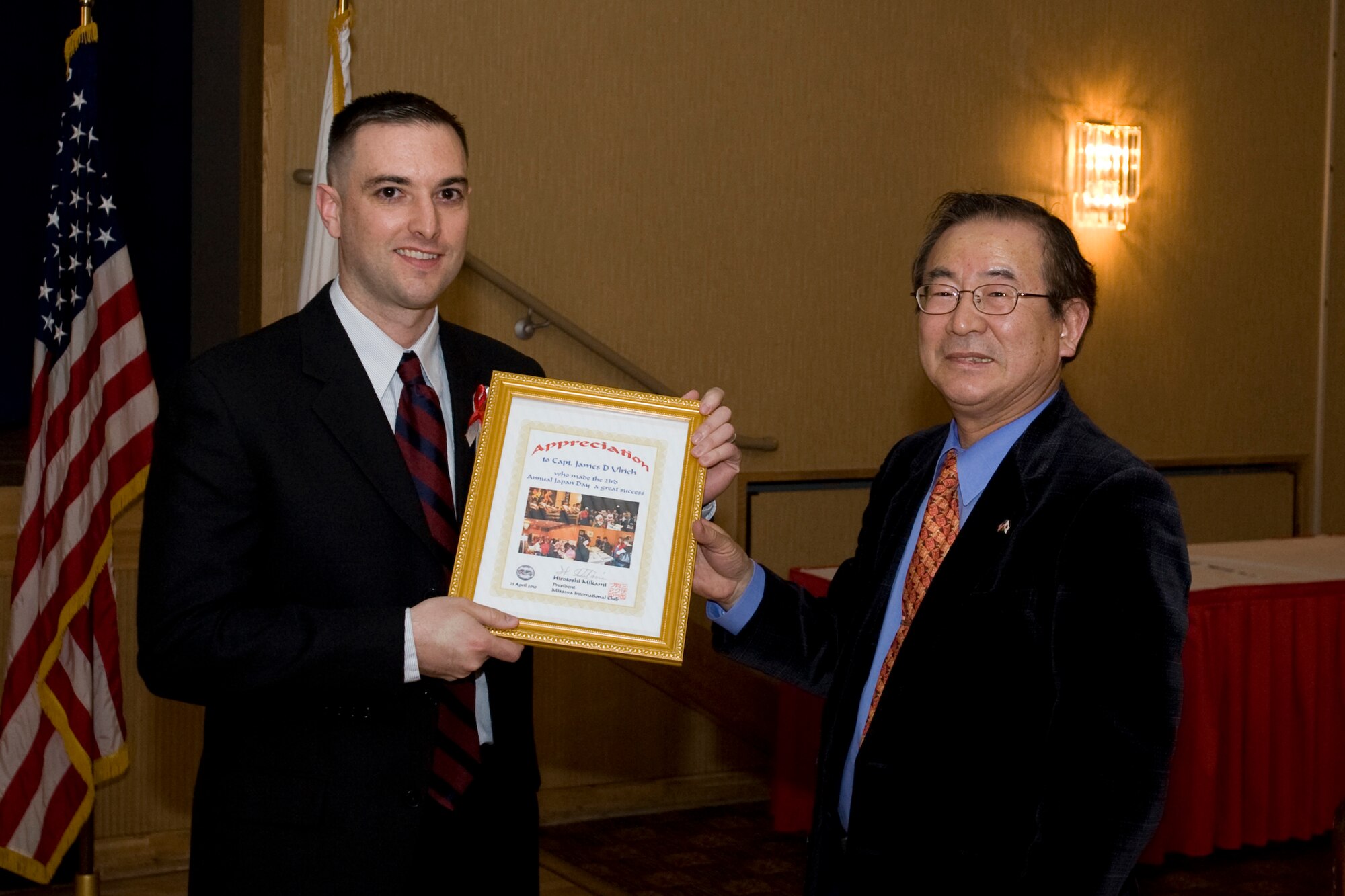 MISAWA AIR BASE, Japan -- Capt. James Ulrich, 2010 Japan Day lead chairperson for Misawa Air Base, receives a letter of appreciation from Hirotoshi Mikami, Misawa International Club president, during the 23rd Annual Japan Day Appreciation Dinner April 23 at the Collocated Club. The dinner officially put a close to Japan Day this year and opened further preparations for the 2010 American Day event which is scheduled for June 6. (U.S. Air Force photo/Senior Airman Jamal D. Sutter)