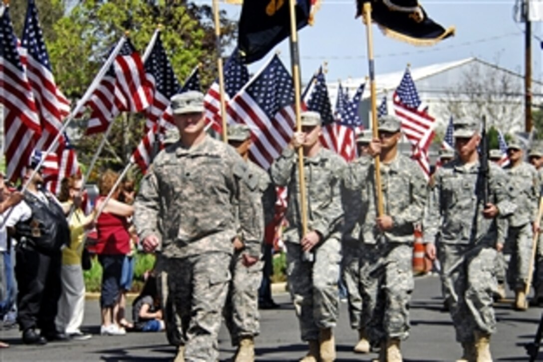 U.S. Army Lt. Col. Gregory Day, front, commander of the 1st Battalion, 186th Infantry, 41st Infantry Brigade Combat Team, Oregon Army National Guard, leads his unit during a parade through Medford, Ore., April 24, 2010. The unit demobilized during a ceremony following its 400-day deployment in Iraq as part of the largest mobilization of Oregon Guard members since World War II. 