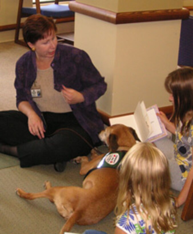 Children enjoyed reading to the therapy dog that visited the Library during one of our popular summer programs.