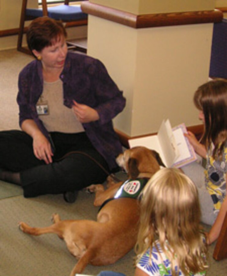 Children enjoyed reading to the therapy dog that visited the Library during one of our popular summer programs.