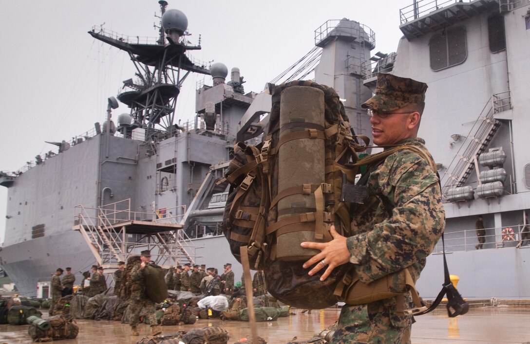 Marines prepare to board USS Tortuga, which will require them to take gear and equipment on the gangplank, up and down steep staircases and through narrow passage ways to their berthing areas. The Landing Force, participating in Cooperation Afloat Readiness and Training 2010, embarked on USS Tortuga to Southeast Asian April 28.