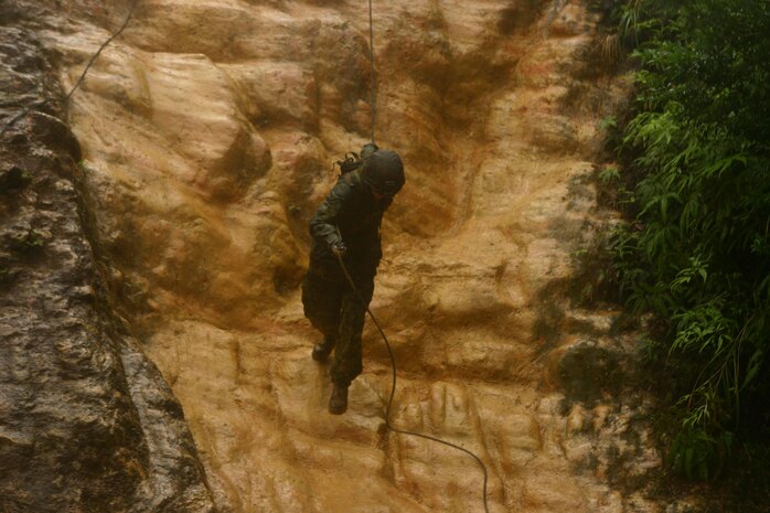 A Marine with Battalion Landing Team 2nd Battalion, 7th Marines (BLT 2/7), 31st Marine Expeditionary Unit (MEU), uses a hasty sling to rappel down a 40 foot cliff during independent training at the Camp Gonsalves Jungle Warfare Training Center, April 27. The independent training was a rehearsal for the Endurance Course, a more than three mile hike through thick jungle terrain, where Marines must negotiate 32 obstacles designed to challenge them physically and mentally.  (Official Marine Corps photo by Cpl. Michael A. Bianco)