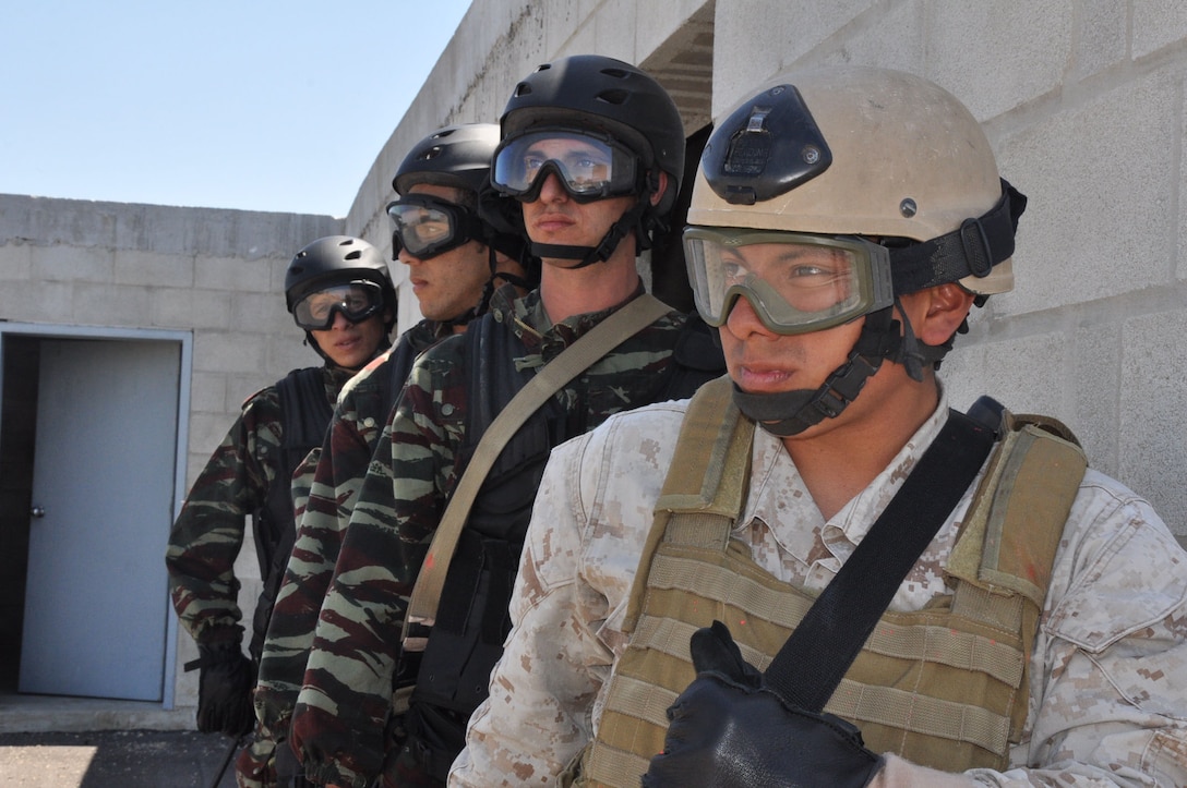 A U.S. Marine assigned to Fleet Anti-terrorism Security Team (FAST), Company Europe at Naval Station Rota, Spain wait with members of a Moroccan Maritime Interdiction Operations team to board a Spanish navy Augusta Bell 212 Helicopter before conducting Helicopter Rope Suspension Technique training in preparation for Exercise Phoenix Express 2010, April 27.  The goals of the exercise are to increase participating countries knowledge base and experience level with FAST unit core capabilities and highlight common safety and security concerns in the maritime environment such as illegal immigration, criminal activity, narcotics trafficking, and weapons trafficking. (U.S. Navy photo by Mass Communication Specialist 1st Class Paul Cage/Released)
