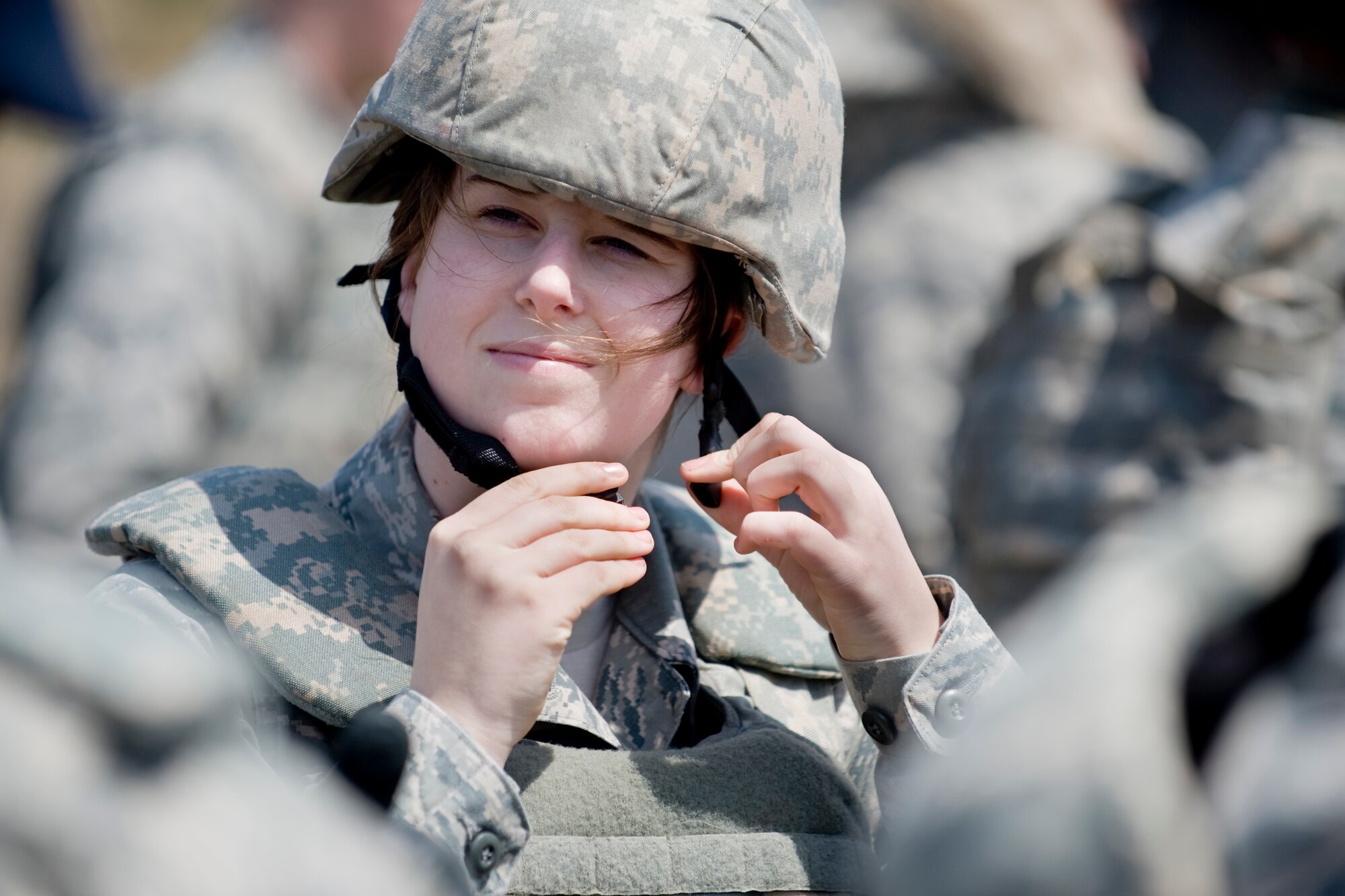 MISAWA AIR BASE, Japan -- Airman 1st Class Summer Robins, 35th Security Forces Squadron patrolman, fastens her helmet in preparation for M203 grenade launcher training April 27 at Draughon Range. Twenty Airmen from the 35th SFS participated in the training. (U.S. Air Force photo/Senior Airman Jamal D. Sutter)