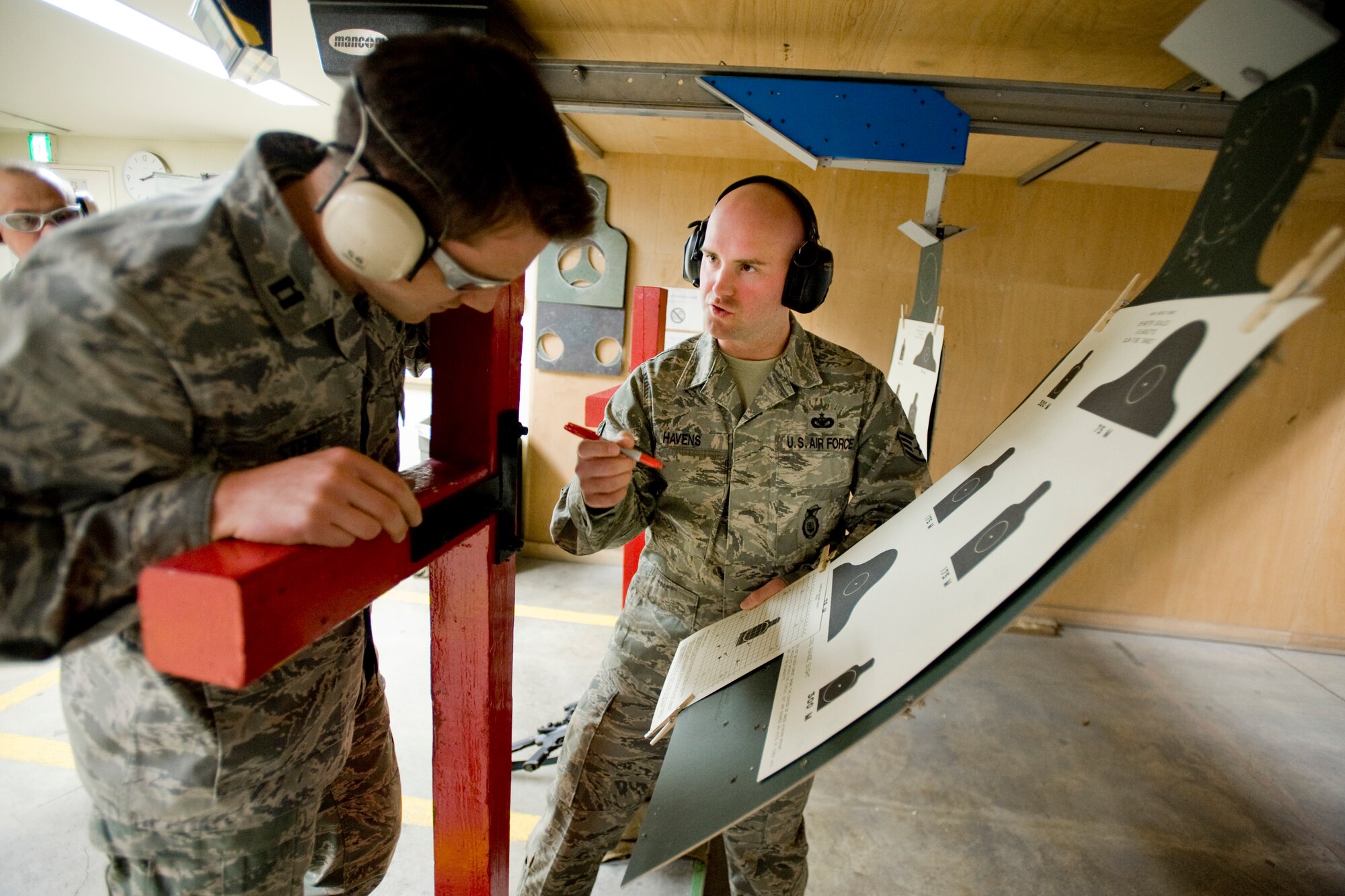 MISAWA AIR BASE, Japan -- Staff Sgt. John Havens, 35th Security Forces Squadron combat-arms instructor, reviews firing results with Capt. Christopher Stein, 35th Fighter Wing chief of military justice, during M4A1 training April 27 at the combat arms training and maintenance range. The training was part of a combat arms course that familiarized Airmen with the M4A1 and other weapons in preparation for upcoming deployments. (U.S. Air Force photo/Senior Airman Jamal D. Sutter)