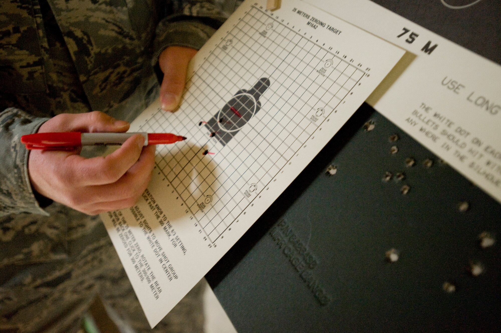 MISAWA AIR BASE, Japan -- Staff Sgt. John Havens, 35th Security Forces Squadron combat-arms instructor, reviews firing results April 27 at the combat arms training and maintenance range. Combat-arms training allows service members to demonstrate their proficiency with various firing weapons. (U.S. Air Force photo/Senior Airman Jamal D. Sutter)