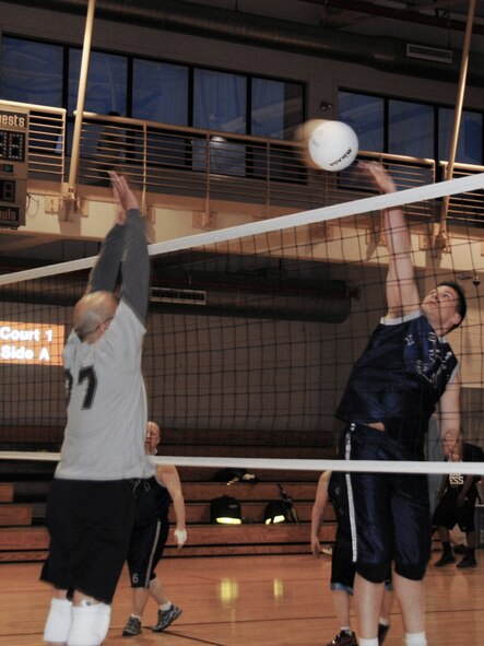 The 51st Fighter Wing intramural volleyball team, left, competes against the 694th Intelligence Group team April 27 at the fitness center on Osan Air Base, Republic of Korea. The 694th IG team won in straight sets, improving their record to 7-1. The 51st FW team, comprised of the 51st Comptroller Squadron and wing staff agencies, dropped to 5-3. Four games remain in the regular season, which concludes May 13. (U.S. Air Force photo/Staff Sgt. Eric Burks)
