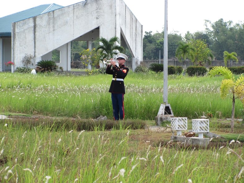 Marine Sgt. Aaron Wagners, bugler from the 3rd Marine Band on Okinawa, plays taps during the funeral for Tech. Sgt. Raymond Natividad, who was recently buried in the Philippines, April 27, 2010. Members of the Kadena Air Base Honor Guard performed the funeral detail in the Philippines with the help of a firing team from the Philippine army. Several U.S. and Philippine organizations worked together to arrange for the burial of the U.S. Airmen, fulfilling the wishes of his family. (U.S. Air Force photo/Tech. Sgt. Brian Roberts) 