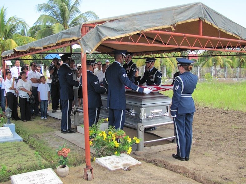 Staff Sgt. Lacey Brown (right) salutes as members of the Kadena Air Base Honor Guard fold the American flag during a funeral detail in the Philippines, April 27, 2010. A firing team from the Philippine rendered the 21-gun salute, finishing out the full honors ceremony. Several U.S. and Philippine organizations worked together to arrange for the burial of the U.S. Airmen, fulfilling the wishes of his family. (U.S. Air Force photo/Tech. Sgt. Brian Roberts) 
