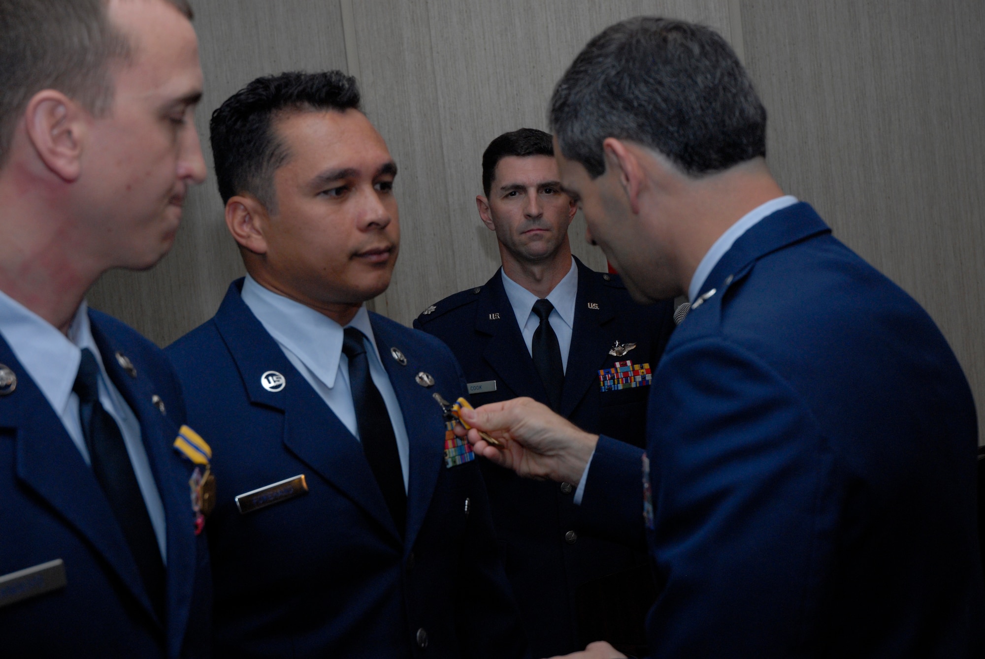 KADENA AIR BASE, Japan -- Brig. Gen. Ken Wilsbach, 18th Wing commander, pins the Air Force Commendation Medal on Staff Sgt. Abraham Forehand, a combat controller with the 320th Special Tactics Squadron, during a ceremony here April 26. Sergeant Forehand and Staff Sgt. Aaron Sanders, from the 31st Rescue Squadron, received the Air Force Commendation Medal for pulling a man pinned under an automobile after an off-base accident March 3. (U.S. Air Force photo by Airman 1st Class Jarvie Wallace)