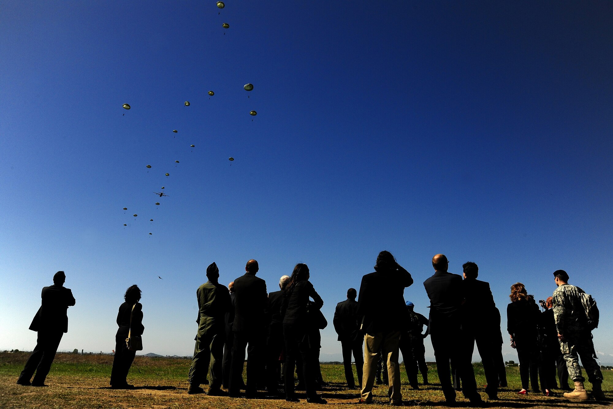 Anu Anguelov, Bulgarian Minister of Defense, and James B. Warlick Jr., U.S. Ambassador to Bulgaria, and their staff watch U.S. and Bulgarian paratroopers jump from a U.S. Air Force C-130J during Thracian Spring 2010’s media day at Plovdiv Airport, April 27, 2010. Thracian Spring is an exercise composed of aircrew, maintenance, airfield management, aerial port, security forces, and logistics personnel that combine their skill in an effort to build and strengthen the United States and Bulgarian Air Forces’ bond while improving interoperability with our partner NATO nation. (U.S. Air Force photo by Master Sgt. Quinton T. Burris)