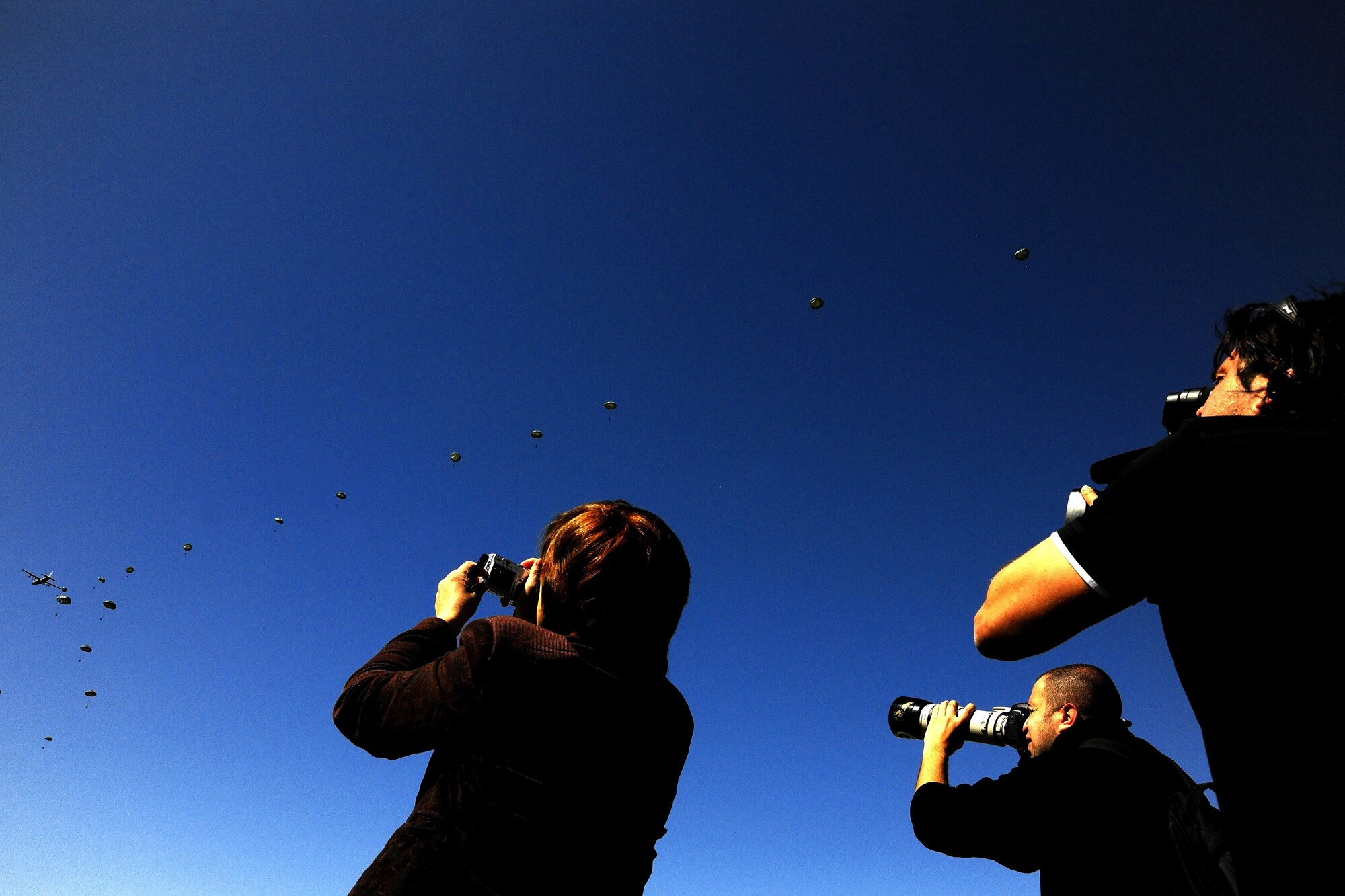 Members of the Bulgarian media capture footage of U.S. and Bulgarian paratroopers jumping from a U.S. Air Force C-130J during Thracian Spring 2010’s media day at Plovdiv Airport, April 27, 2010. Thracian Spring is an exercise composed of aircrew, maintenance, airfield management, aerial port, security forces, and logistics personnel that combine their skill in an effort to build and strengthen the United States and Bulgarian Air Forces’ bond while improving interoperability with our partner NATO nation. (U.S. Air Force photo by Master Sgt. Quinton T. Burris)