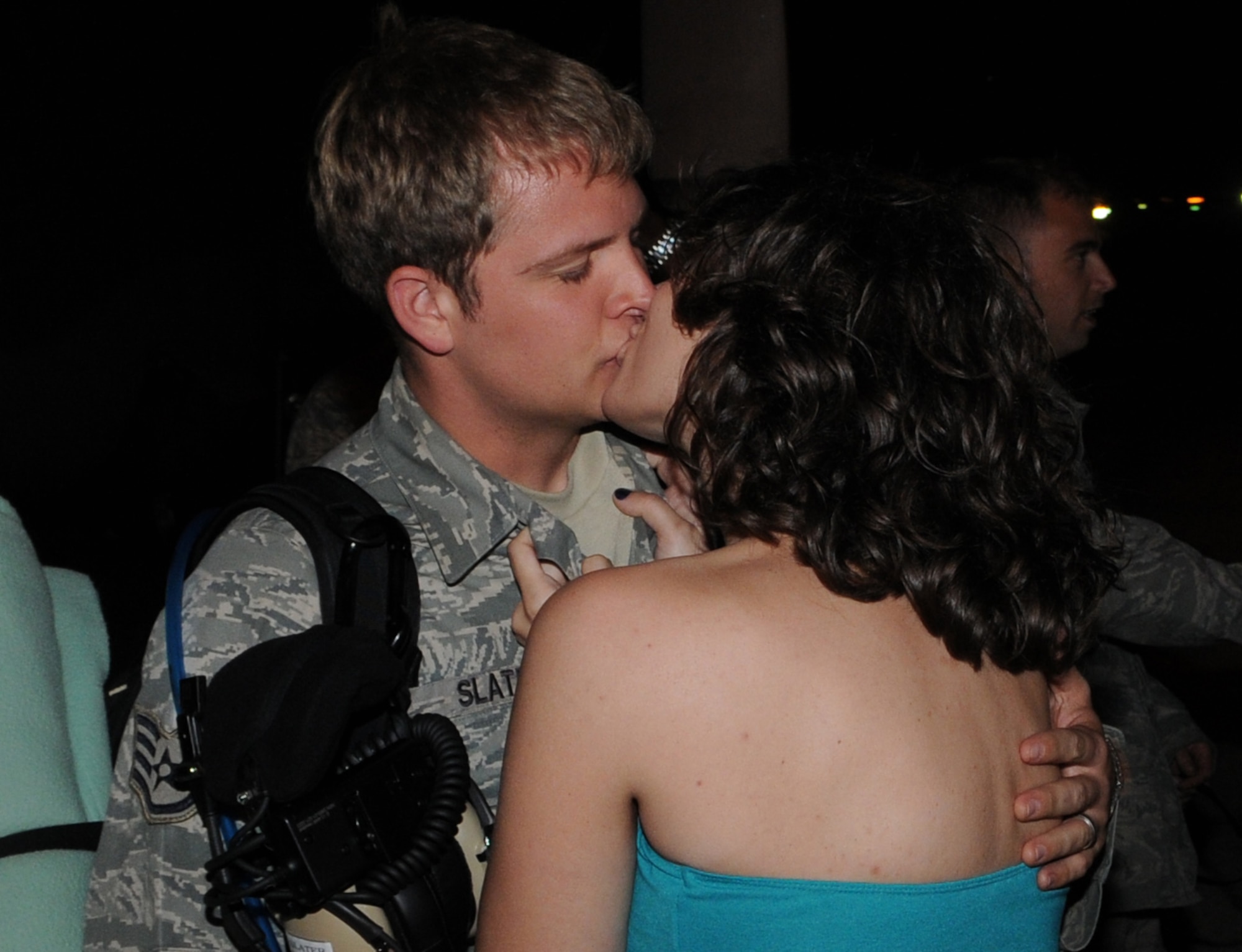 KADENA AIR BASE, Japan -- Staff Sgt. Cory Slater, from the 353rd Maintenance Squadron, kisses his wife Anda at a welcome home ceremony here April 25 after returning from a four-month deployment supporting combat operations in Afghanistan. (U.S. Air Force photo by Tech. Sgt. Aaron Cram)
