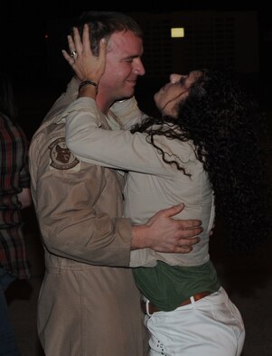 KADENA AIR BASE, Japan -- Staff Sgt. Clayton Slater, from the 17th Special Operations Squadron, holds his wife Carolina at a welcome home ceremony here April 25 after returning from a four-month deployment supporting combat operations in Afghanistan. (U.S. Air Force photo by Tech. Sgt. Aaron Cram)