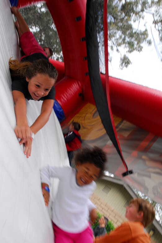 VANDENBERG AIR FORCE BASE, Calif. -- Dependents slide down a mock fire escape slide during the Team Vandenberg Kids' Carnival at Cocheo Park here Saturday, April 24, 2010.  The carnival was aimed to promote awareness for the month of the military child, child abuse awareness, sexual assault awareness and alcohol awareness.  (U.S. Air Force photo/Senior Airman Andrew Satran) 

 

 

 

 
 

 