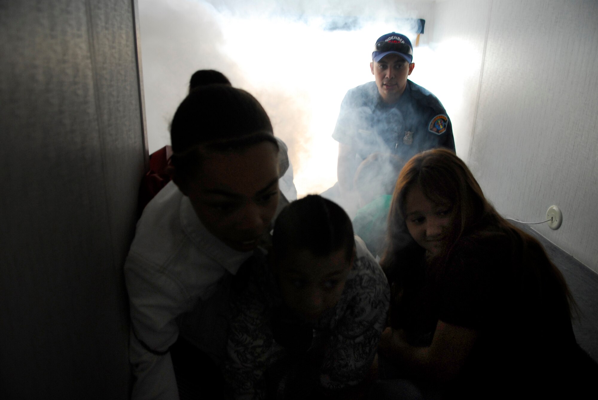 VANDENBERG AIR FORCE BASE, Calif. -- Paul Martinez, 30th Civil Engineer Squadron firefighter, teaches dependents basic home fire safety techniques in a fire safety house during the Team Vandenberg Kids' Carnival at Cocheo Park here Saturday, April 24, 2010.  The carnival showcased a variety of Vandenberg unit's tools of the trade for a hands-on experience.  (U.S. Air Force photo/Senior Airman Andrew Satran) 

  

 

 
 

 