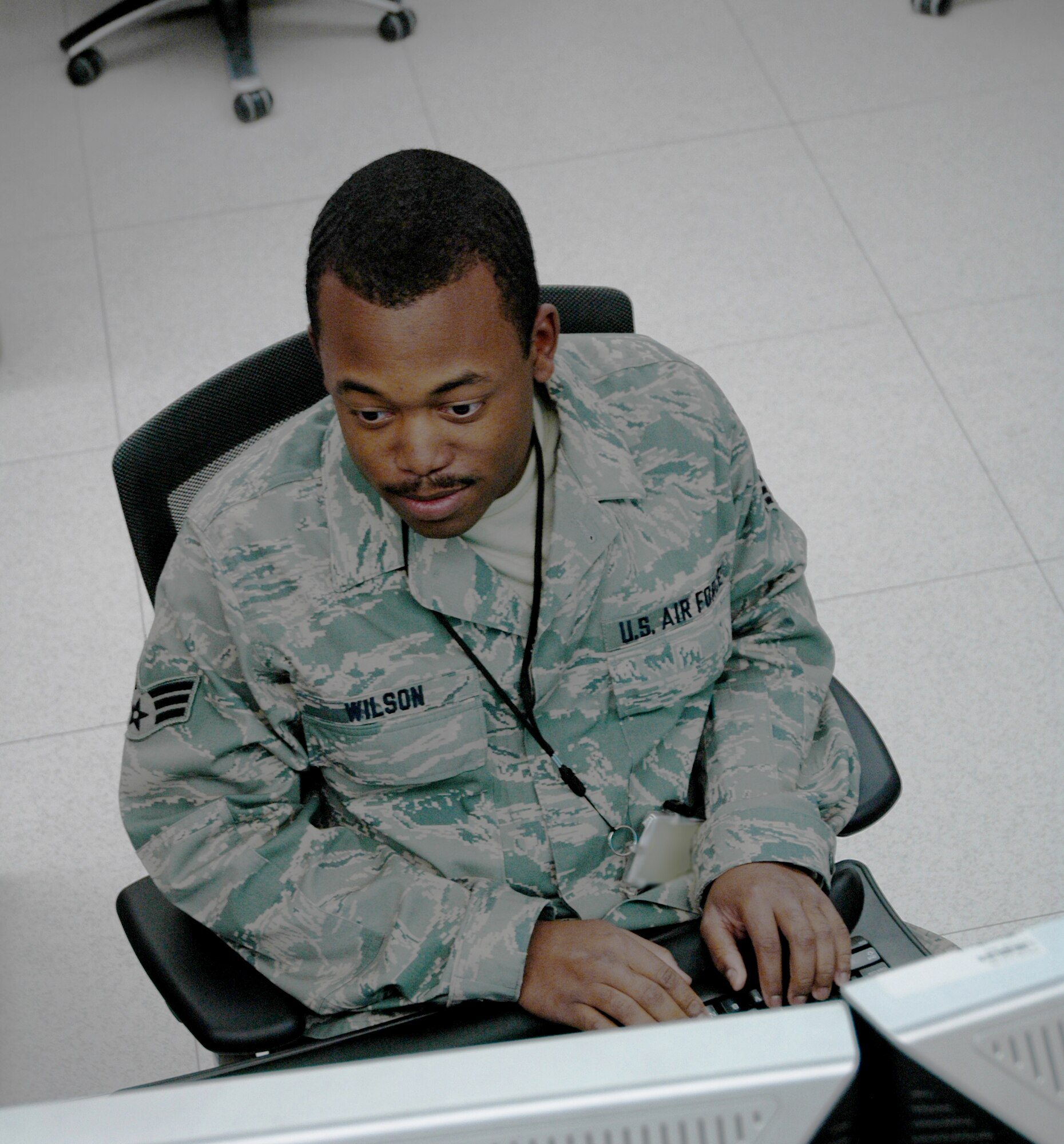 Senior Airman Armani Wilson writes computer code April 16, 2010, in the Combined Air and Space Operations Center. Airman Wilson is a combat coder software engineer.(U.S. Air Force photo illustration/Senior Airman Dillon White)
