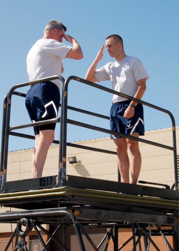 Brig. Gen. O.G. Mannon, 82nd Training Wing commander, coins the 82nd Training Wing master of drill and ceremonies, for setting the example and being an exemplary Airman after the Wing Run April 23, 2010. Sergeant Gust wrote a commentary “Eyes Right”, in which he spoke about the team effort and pride of the 82nd TRW during every parade at Sheppard. (U.S. Air Force photo/Mike Litteken)