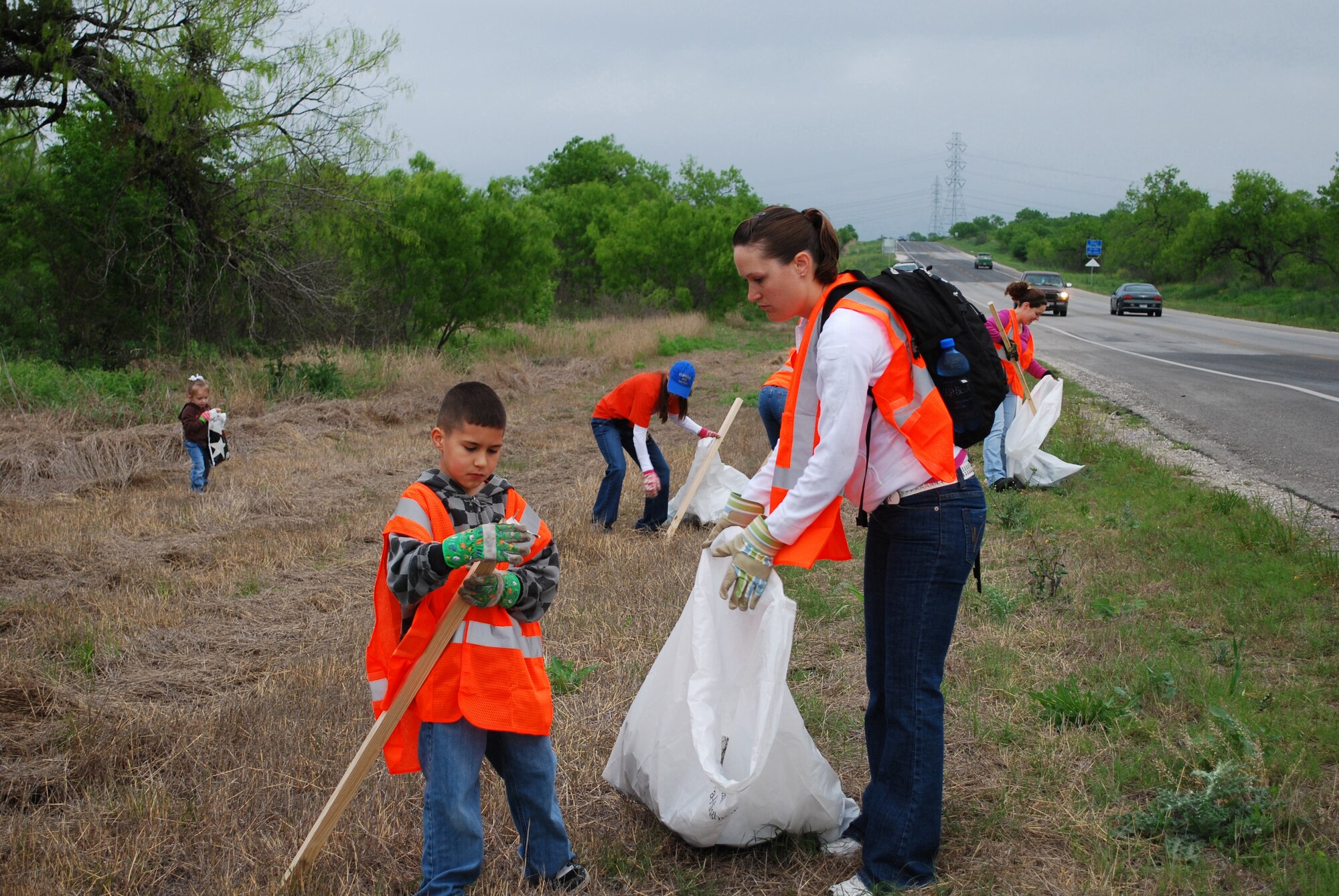 Staff Sgt. Danielle Miranda, 59th Medical Inpatient Squadron, and her 9-year-old son, Alex, pick up trash April 10, along a section of State Highway 1604, the squadron's adopted highway. Squadron members and their families participated in the Don't Mess with Texas Trash-Off, the single largest one-day cleanup event in the state. The campaign is Texas? signature event for the Great American Cleanup, the nation's largest community improvement program. (U.S. Air Force courtesy photo)
