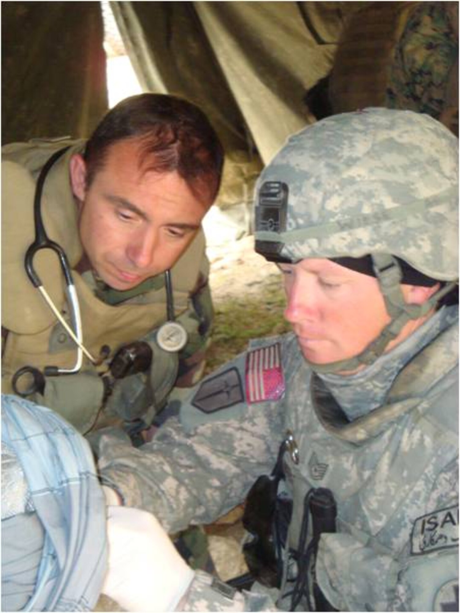 Sergeant Wiese works with French Army physician Lt. Col. Fabien Cardinele during a Village Medical Outreach.  (Courtesy Photo)

