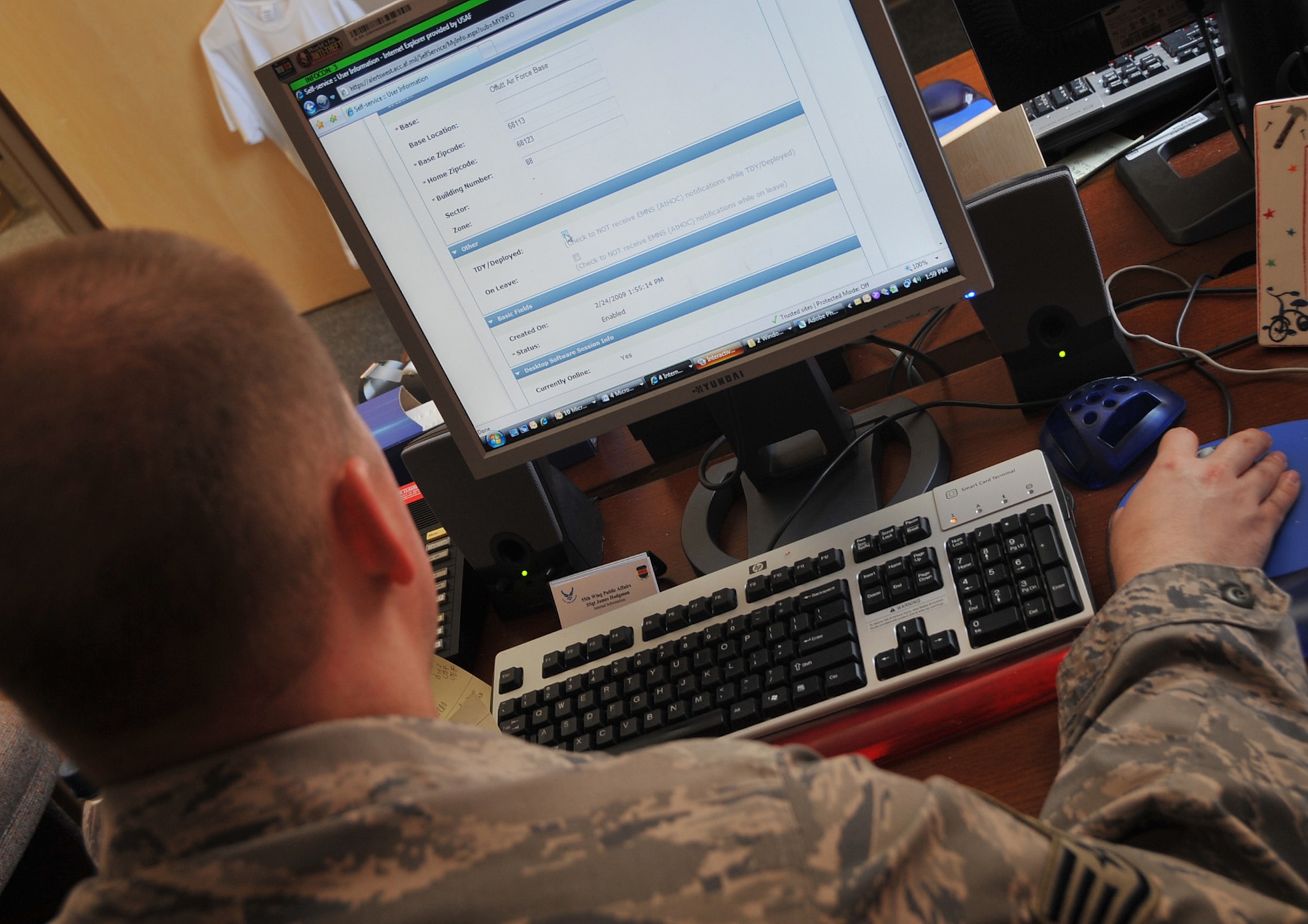 OFFUTT AIR FORCE BASE, Neb. -- Staff Sgt. James M. Hodgman, non-commissioned officer in charge of internal information for the 55th Wing Public Affairs Office, updates his information in the AtHoc emergency notification system. U.S. Air Force Photo by Jeff Gates