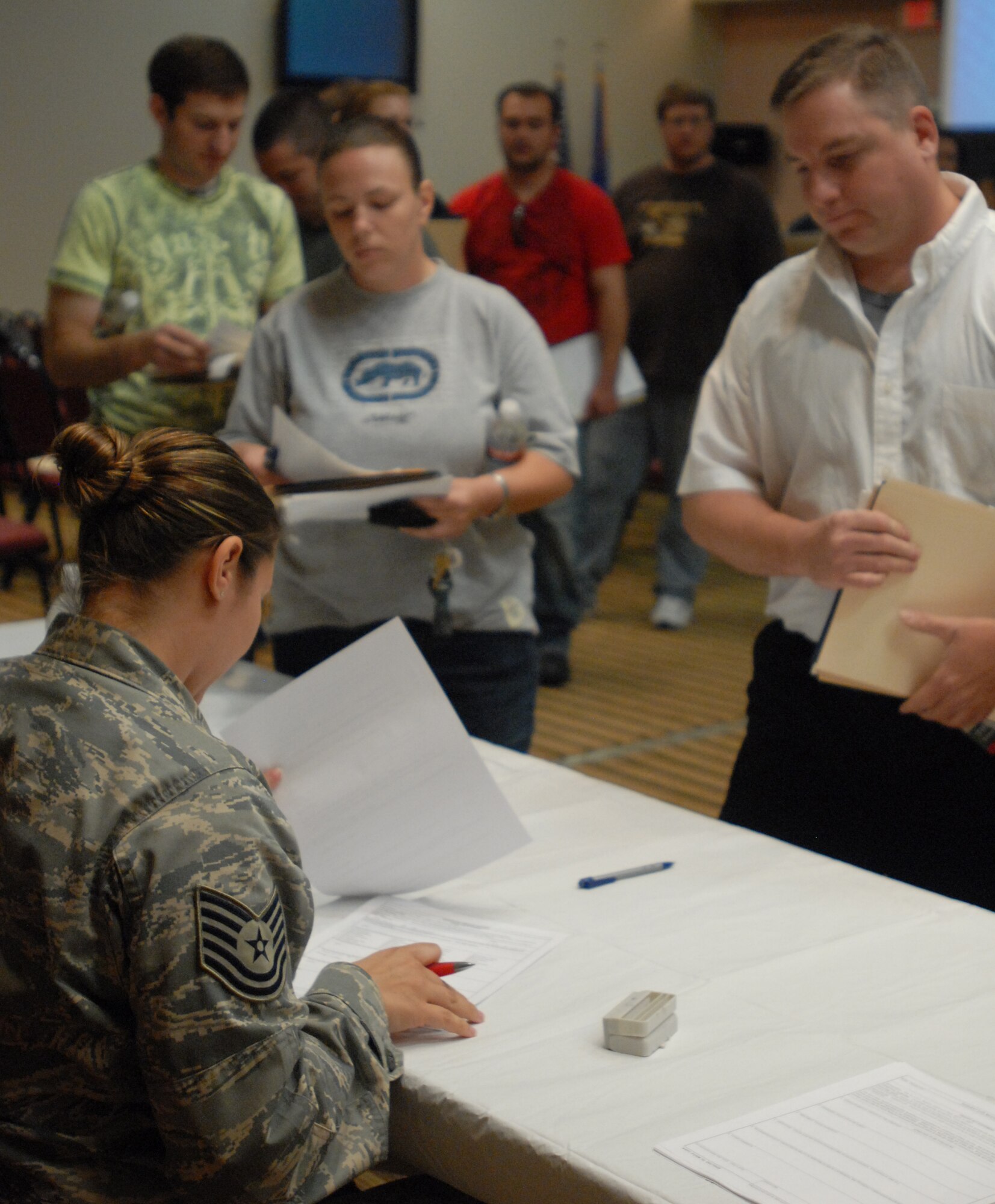 Technical Sgt. Karen Harr, 17th Medical Operations Squadron, collects medical surveys from members of the Individual Ready Reserve during an IRR Muster at Goodfellow AFB, Texas April 23.  A muster is held each year for individuals in the IRR to update personal information and receive information on benefits. (U.S. Air Force photo by Master Sgt. Randy Mallard)