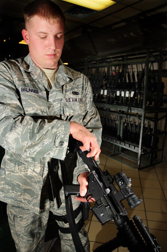 ELLSWORTH AIR FORCE BASE, S.D. -- Senior Airman Tyler Brunner, 28th Security Forces Squadron staff armory personnel, clears a M-4 carbine rifle in the armory.  All weapons in the armory are stored separate from the ammunition to prevent accidents or incidents. (U.S. Air Force photo/Airman 1st Class Anthony Sanchelli)
