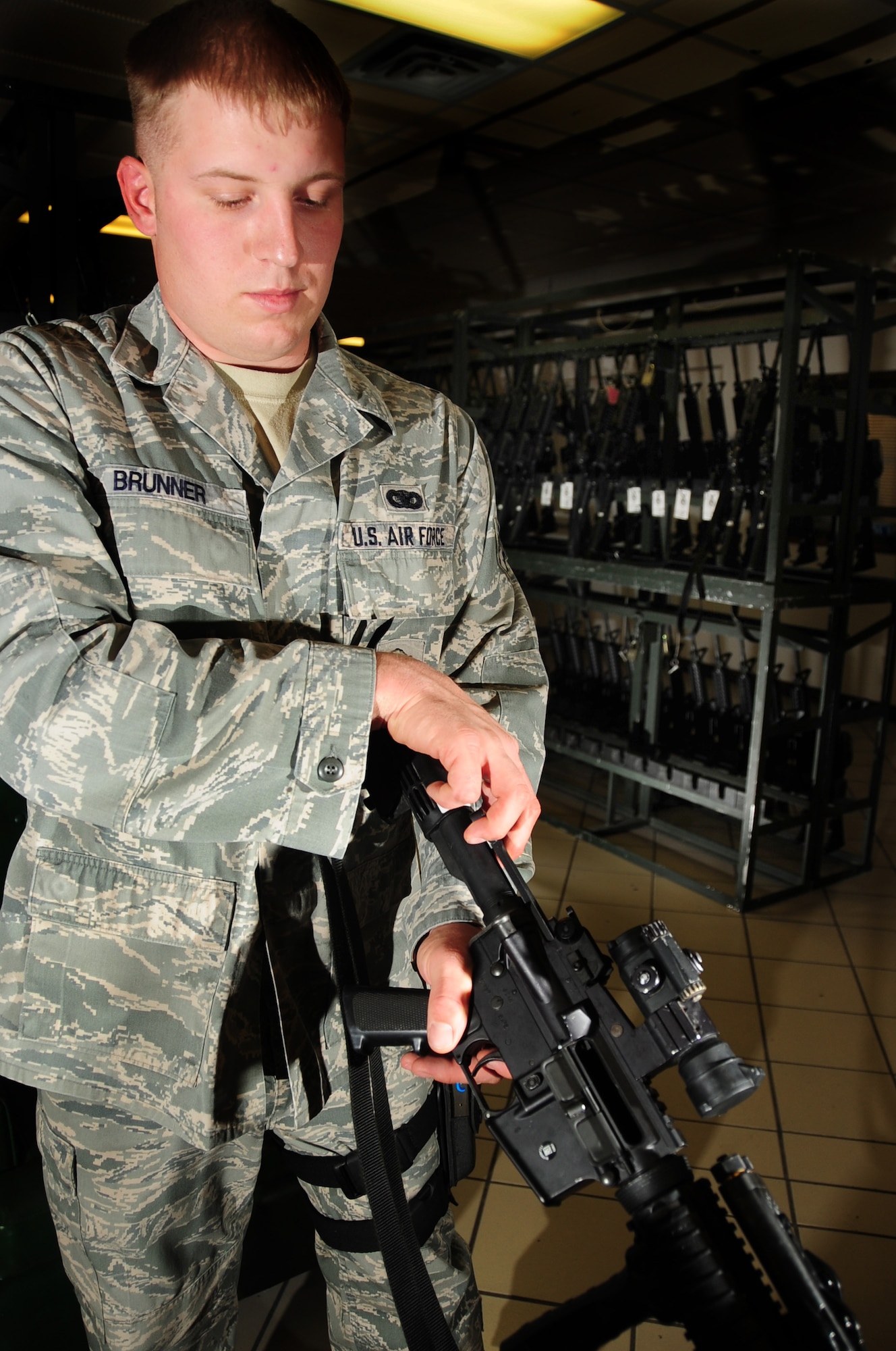 ELLSWORTH AIR FORCE BASE, S.D. -- Senior Airman Tyler Brunner, 28th Security Forces Squadron staff armory personnel, clears a M-4 carbine rifle in the armory.  All weapons in the armory are stored separate from the ammunition to prevent accidents or incidents. (U.S. Air Force photo/Airman 1st Class Anthony Sanchelli)
