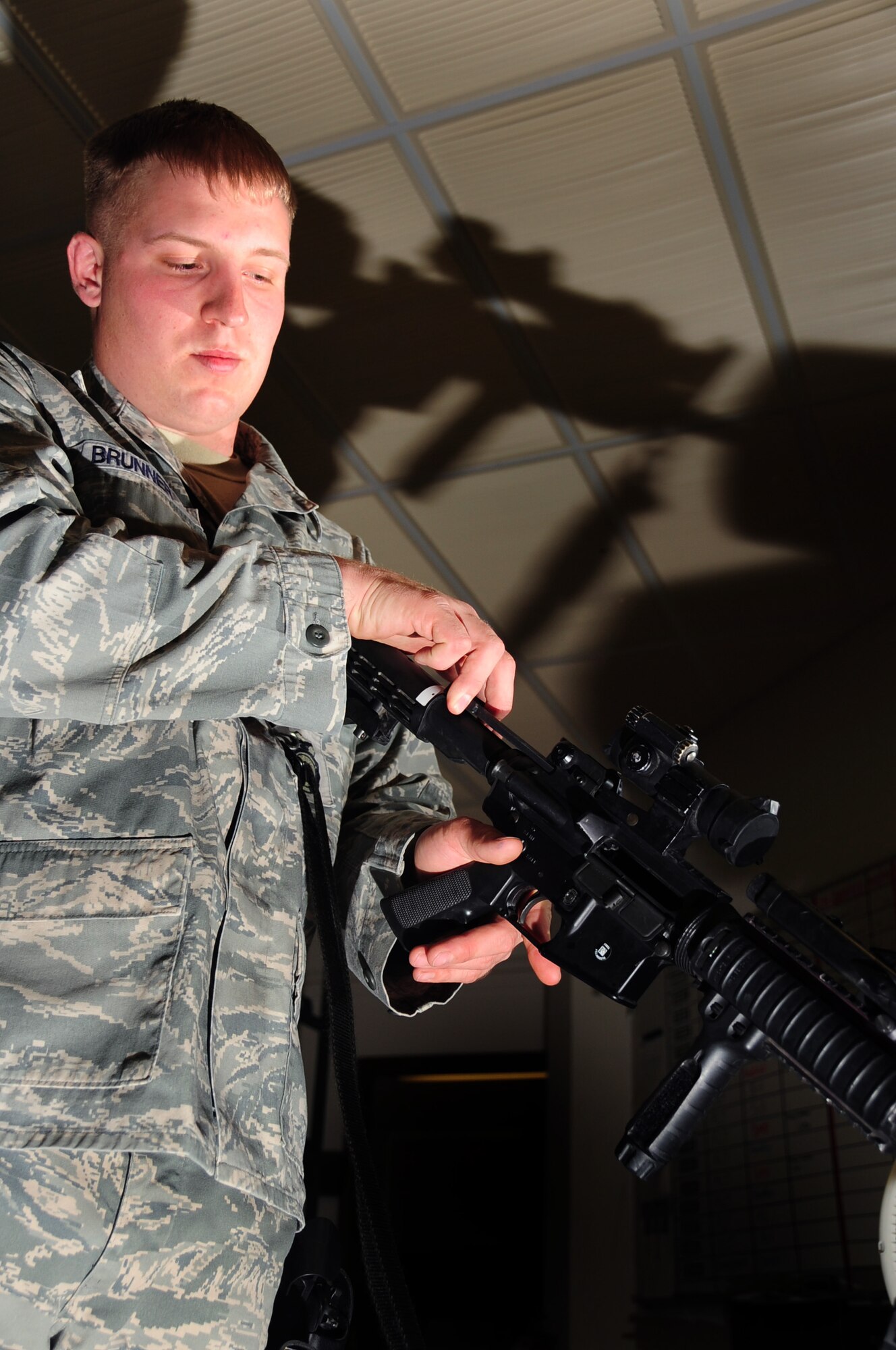 ELLSWORTH AIR FORCE BASE, S.D. -- Senior Airman Tyler Brunner, 28th Security Forces Squadron staff armory personnel, clears a M-4 carbine rifle in the armory.  Clearing the weapon ensures it is not stored while still loaded. (U.S. Air Force photo/Airman 1st Class Anthony Sanchelli)

