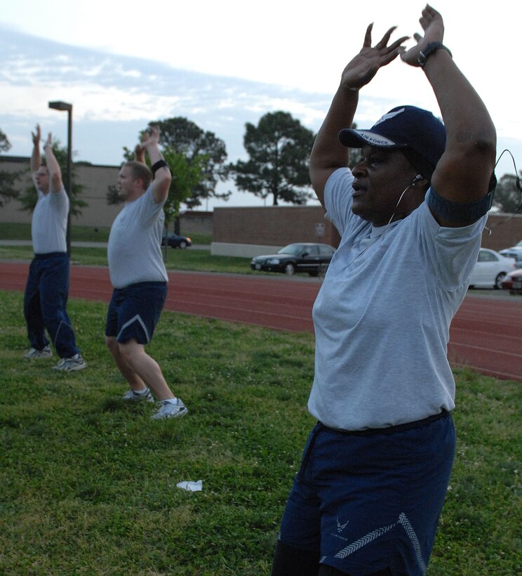 LANGLEY AIR FORCE BASE, Va. - Master Sgt. Harriet Early, Air Combat Command Training Support Squadron program manager, performs jumping jacks during the “Back to Basics” class April 26. The eight-week course is designed to help Airmen improve their physical training performance through a rigorous daily workout program. (U.S. Air Force photo/Airman 1st Class Gul Crockett) 
