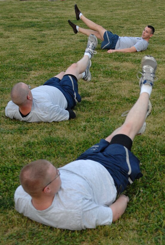 LANGLEY AIR FORCE BASE, Va. - Senior Airman Keith Miller, 633d Force Support Squadron fitness specialist, leads Airmen in flutter kicks during the “Back to Basics” class April 26.The eight-week course is designed to help Airmen improve their physical training performance through a rigorous daily workout program.(U.S. Air Force photo/Airman 1st Class Gul Crockett)

